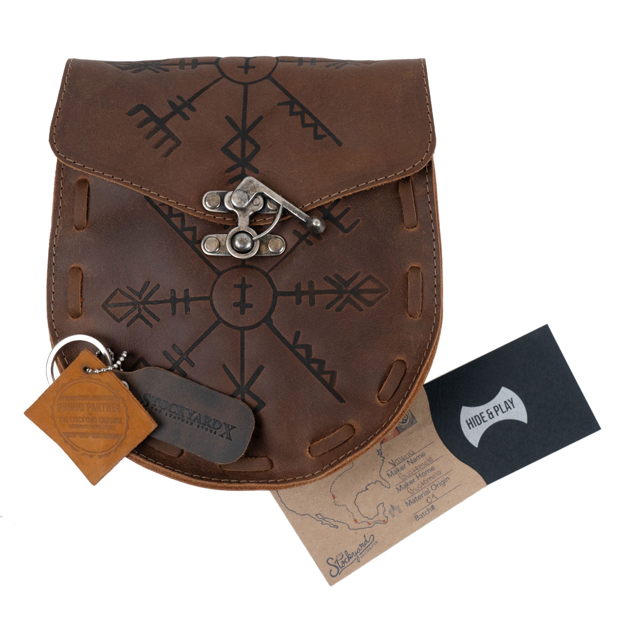 The Rune Belt Pouch by Hide & Play displayed with tags and care information, emphasizes its artisanal quality. This full grain leather medieval style waist bag is an ideal Viking costume accessory, showcasing the craftsmanship of small batch production handmade in La Antigua Guatemala.