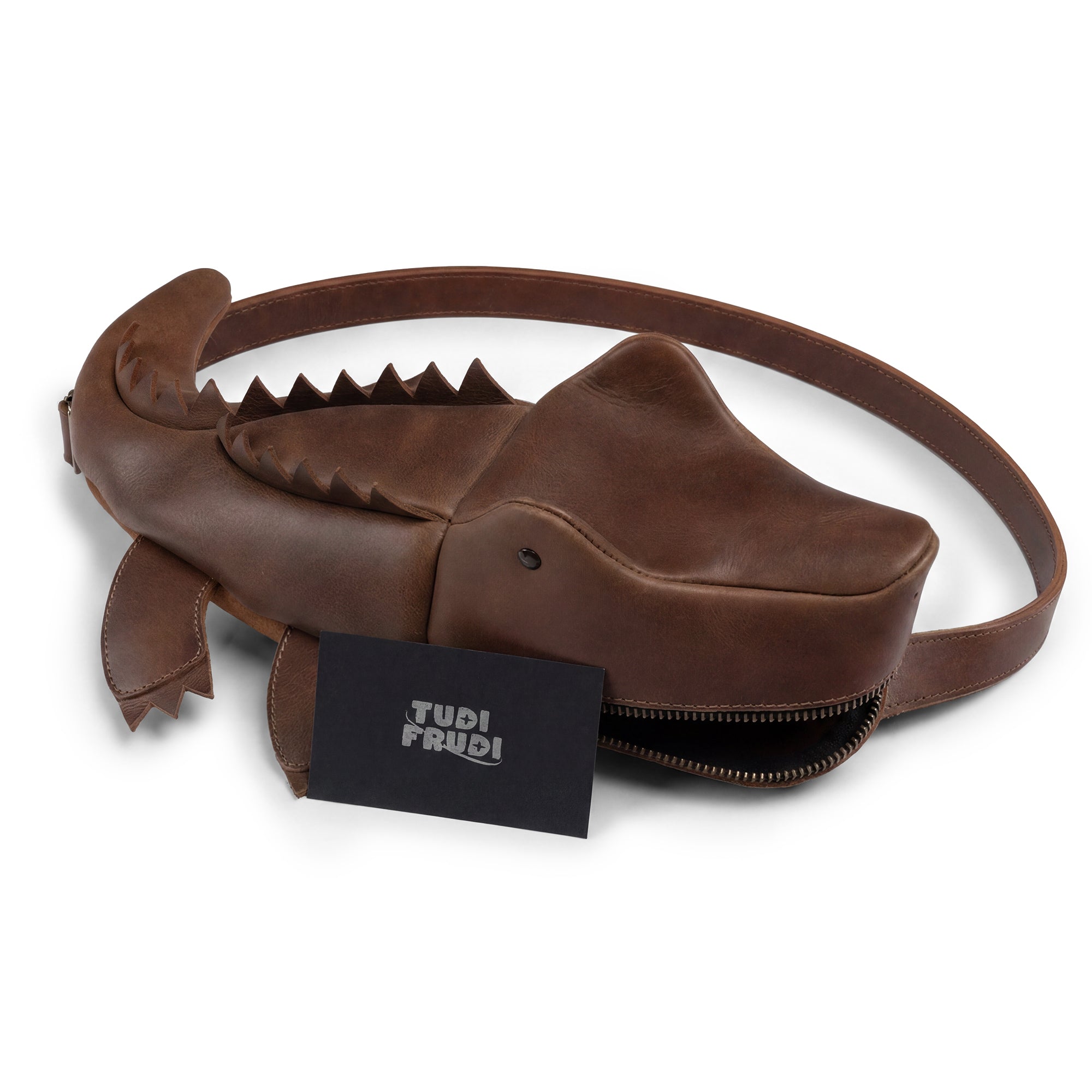 The Crocodile-Shaped Crossbody by Tudi Frudi displayed with its branding, highlighting its authenticity as a Small Batch Production piece. This Full Grain Leather bag is both stylish and practical, ideal for anyone looking for a unique handmade in La Antigua Guatemala & Oaxaca Mexico.