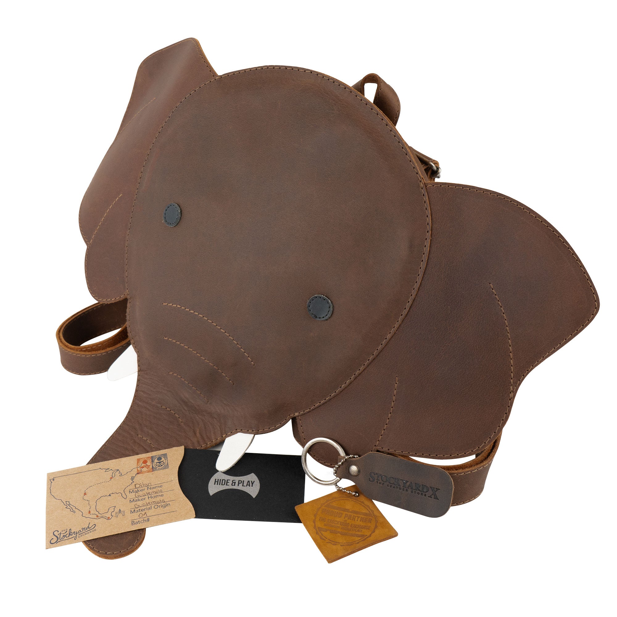 Handmade Elephant-Shaped Backpack by Hide & Play, featuring care instructions and quality details. This distinctive Full Grain Leather bag serves as an Elephant-Shaped Shoulder Bag, ideal as a Messenger Bag or Travel Bag for Men and Women. StockyardX takes pride in its artisan production in La Antigua Guatemala.