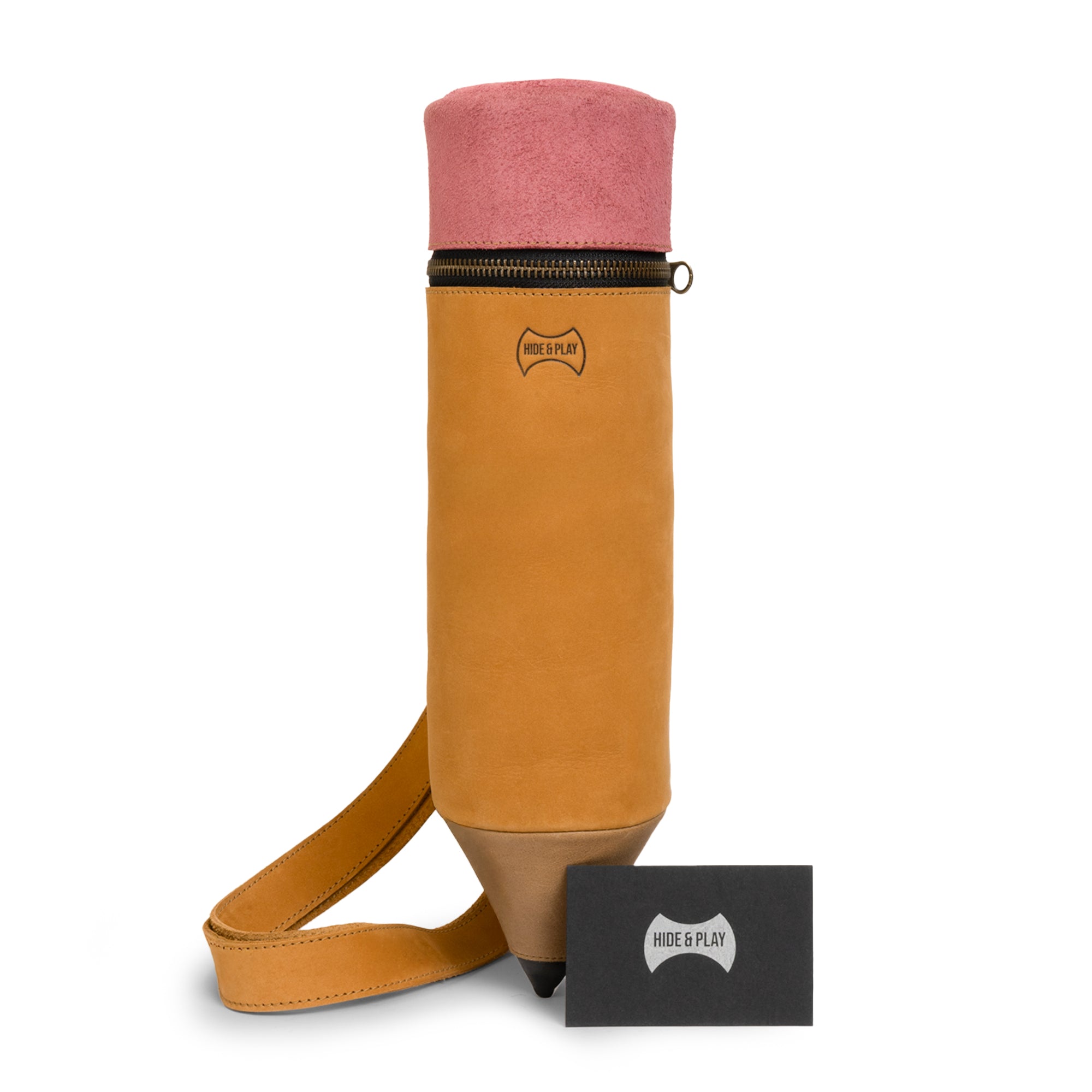 Close look at the Pencil-Shaped Crossbody Bag by Hide & Play, presenting its unique leather design and artisan branding. This Leather Pencil-Shaped Crossbody Bag is made with full grain leather and is perfect for those seeking an original zippered sling bag or travel backpack.