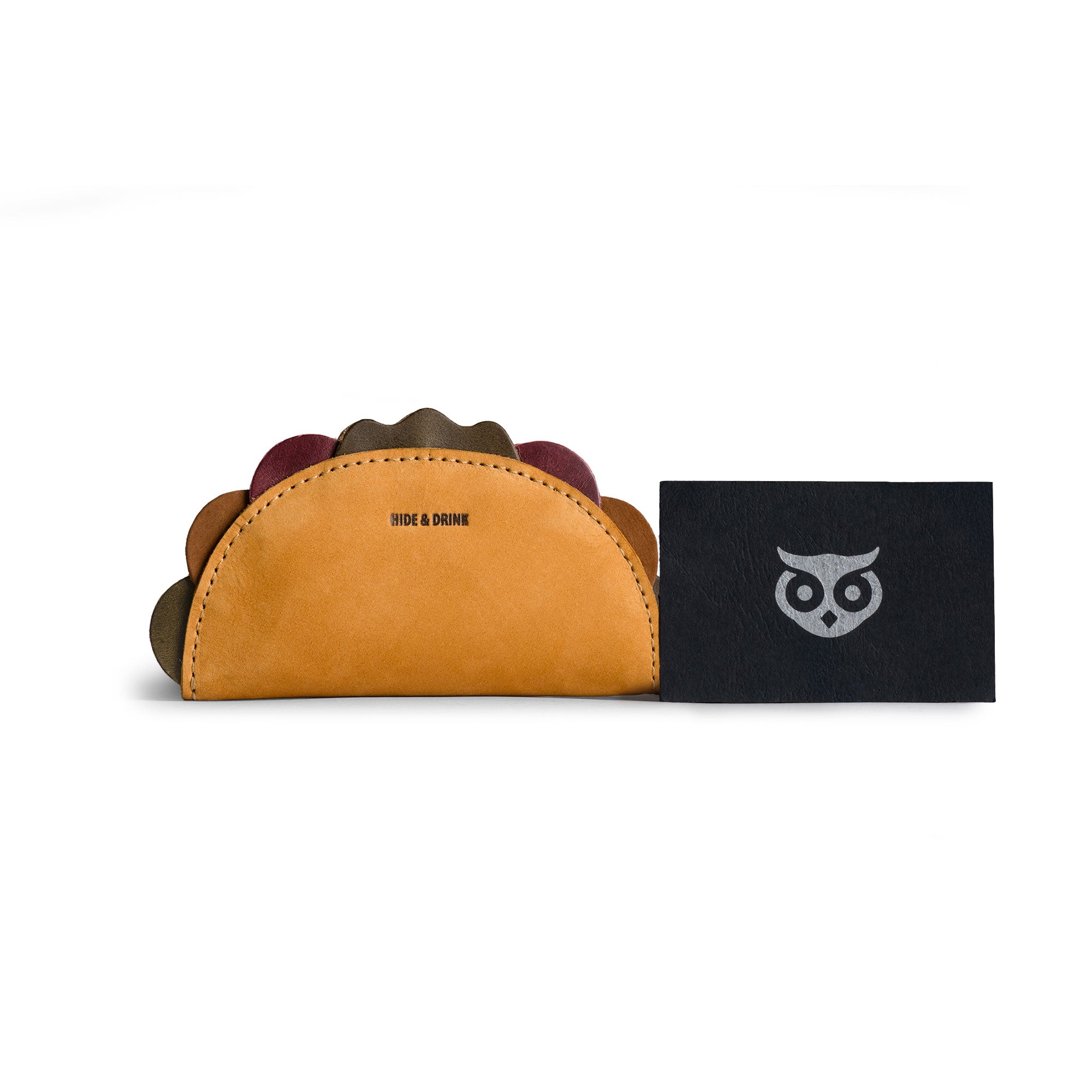 Hide & Drink Taco Zip Pouch Bag Charm Key Chain placed beside keys and tacos on a rustic table, illustrating its food-inspired design and useful everyday carry style. Taco Zip Pouch Bag Charm Key Chain Full Grain Leather, StockyardX, Small Batch Production, Hand Cut, Hand Sewn, Fire Branded, Artisan, Handmade in La Antigua Guatemala & Oaxaca Mexico.