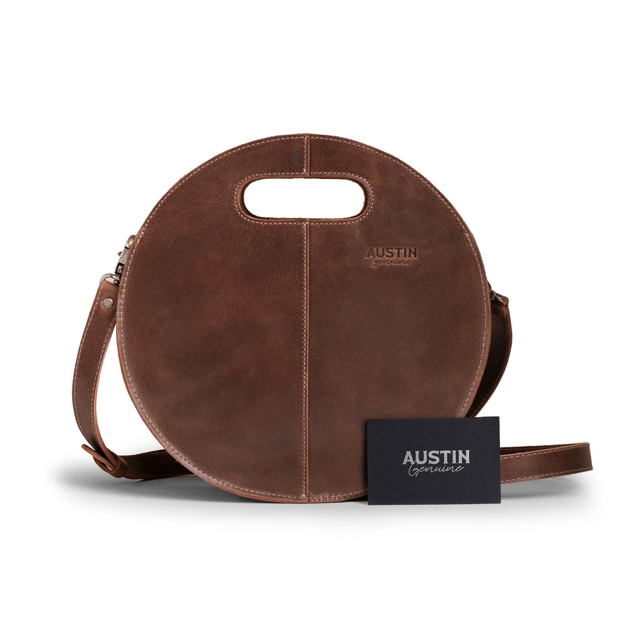 The Pecan Shoulder Bag by Austin Genuine, posed with an accompanying promotional card, showcasing its premium full grain leather design, a product of small batch production reflecting hand cut, hand sewn artistry, fire branded, and crafted in La Antigua Guatemala & Oaxaca Mexico.
