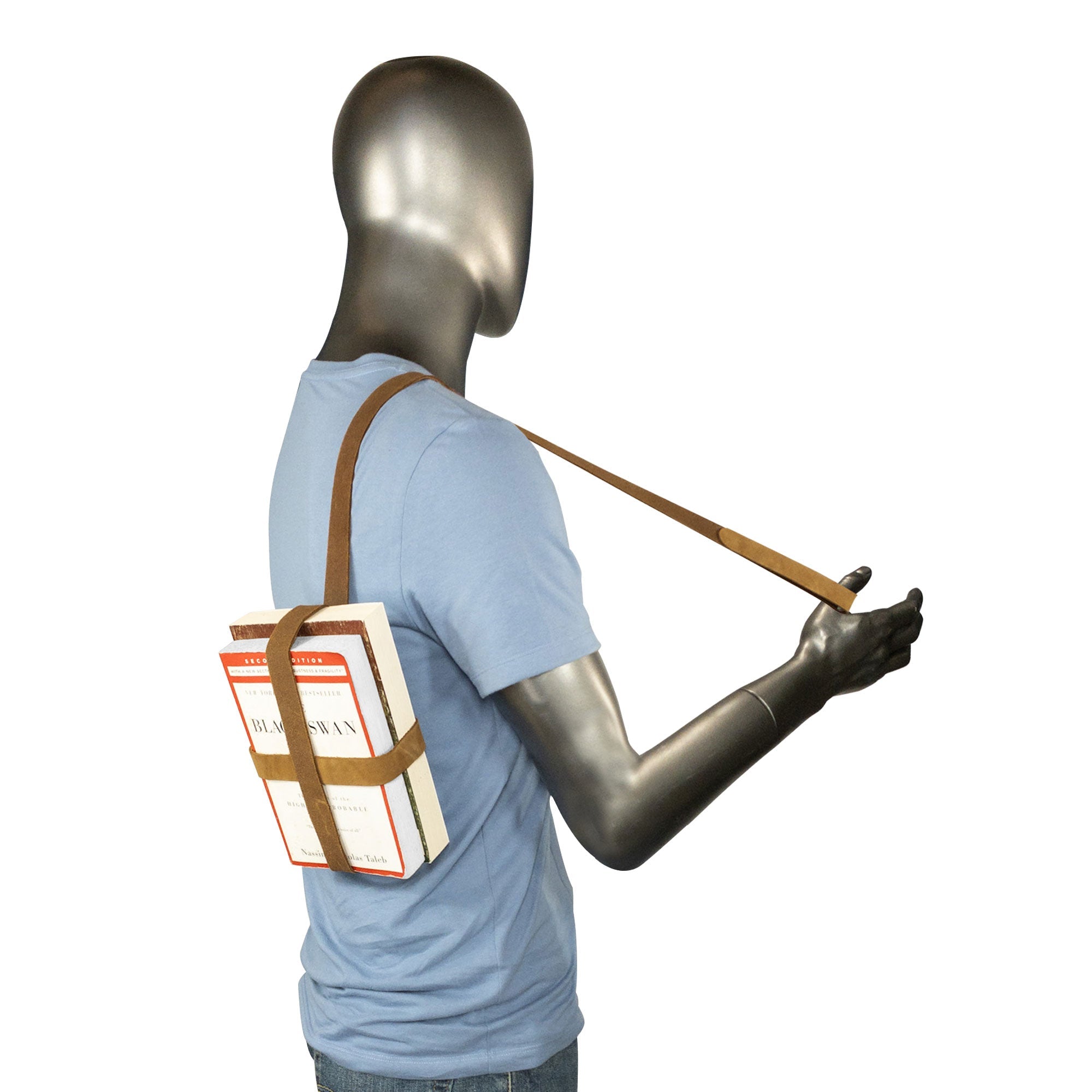 A mannequin wearing the Hide & Drink Book Strap Carrier for books, exemplifying its versatility and comfort. Made of Full Grain Leather, this artisan product from La Antigua Guatemala is ideal for stylish readers.