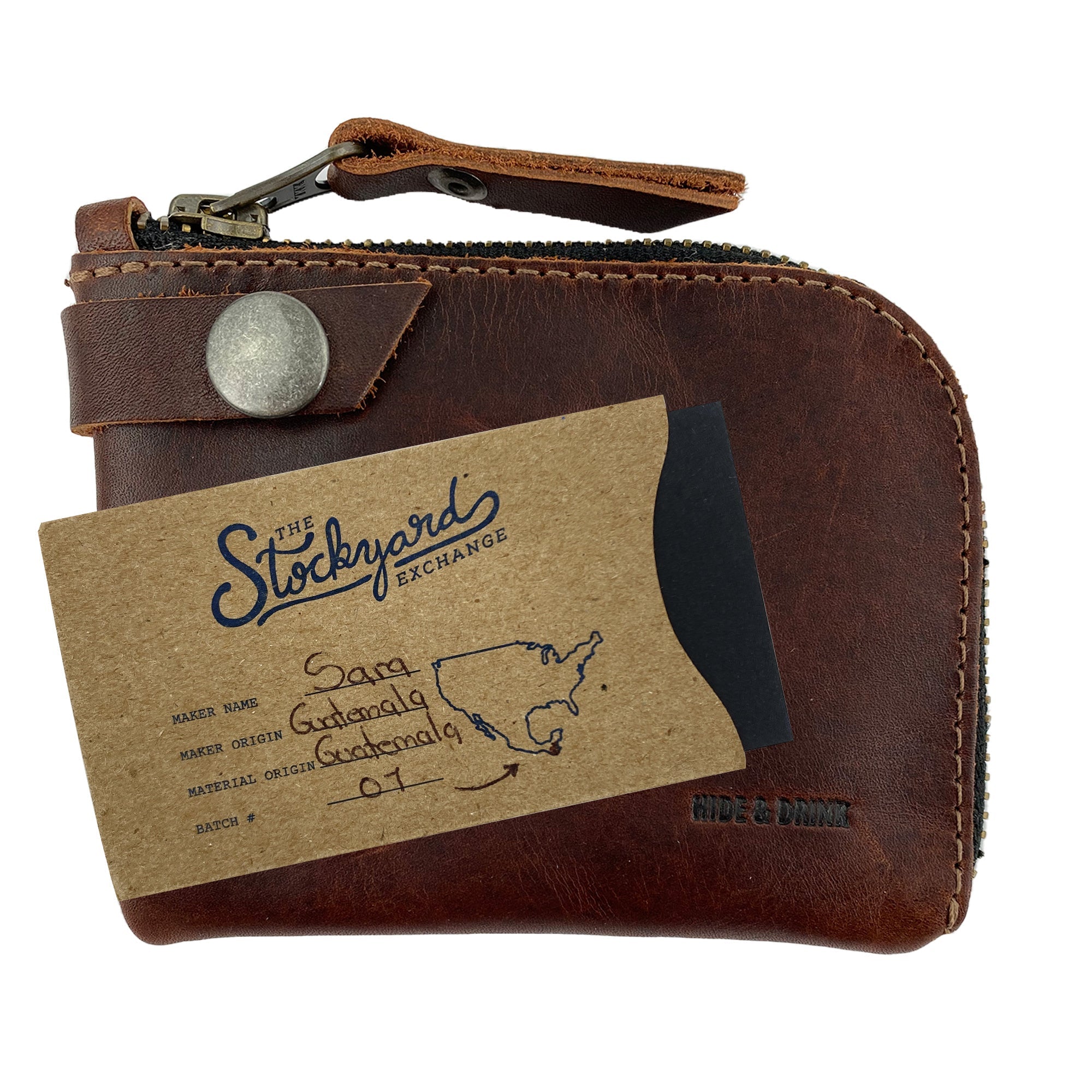Lion's Mane Zippered Wallet by Hide & Drink with a stylish card and paper label. Crafted from full grain leather, it represents fine artisan quality and is perfect for carrying essentials in a compact format.