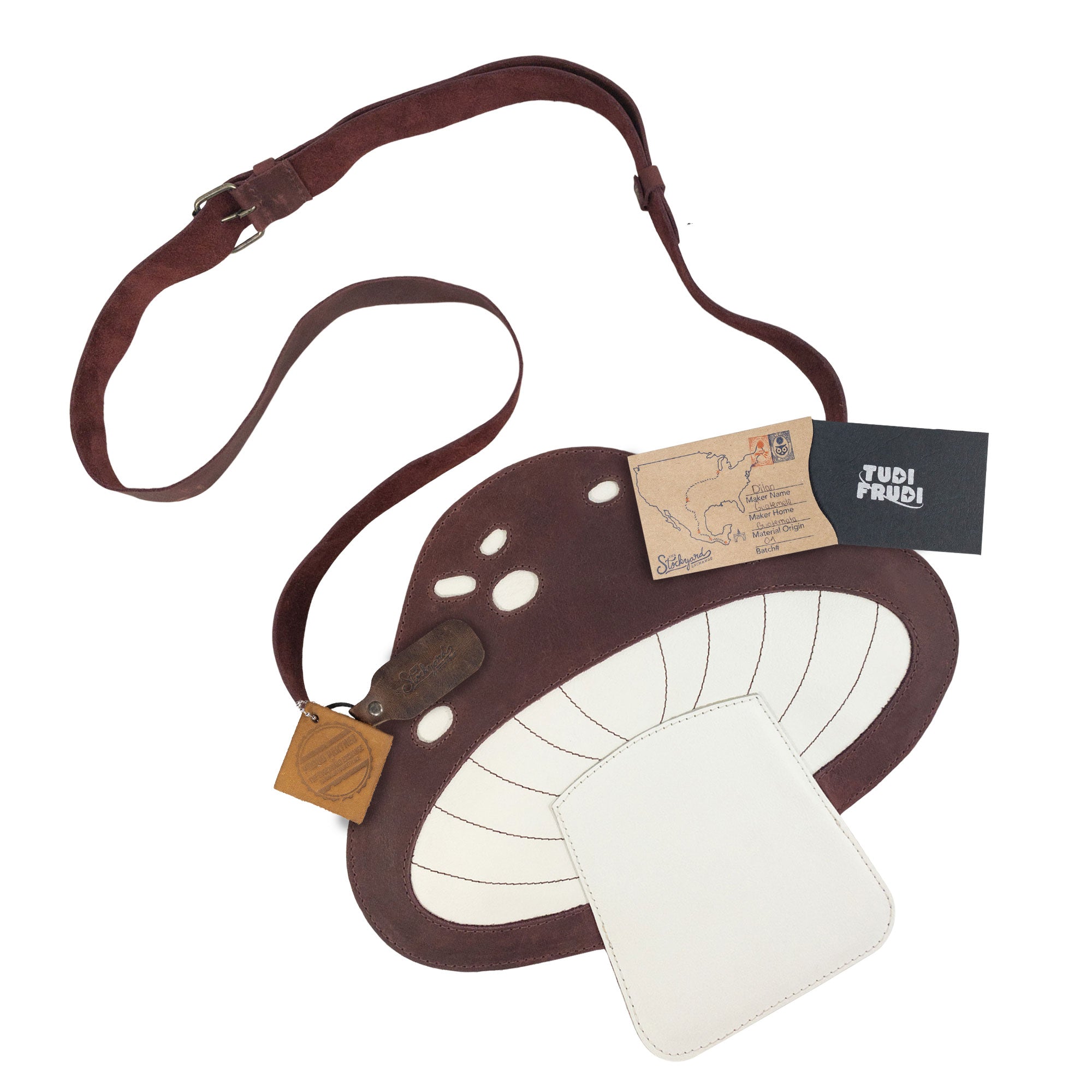 The Mushroom-Shaped Leather Shoulder Bag by Tudi Frudi, complete with tags and branding, showcasing its unique handmade qualities. This bag is perfect for use as a crossbody or messenger bag, made from Full Grain Leather with small batch production, reflecting artisan craftsmanship from La Antigua Guatemala.