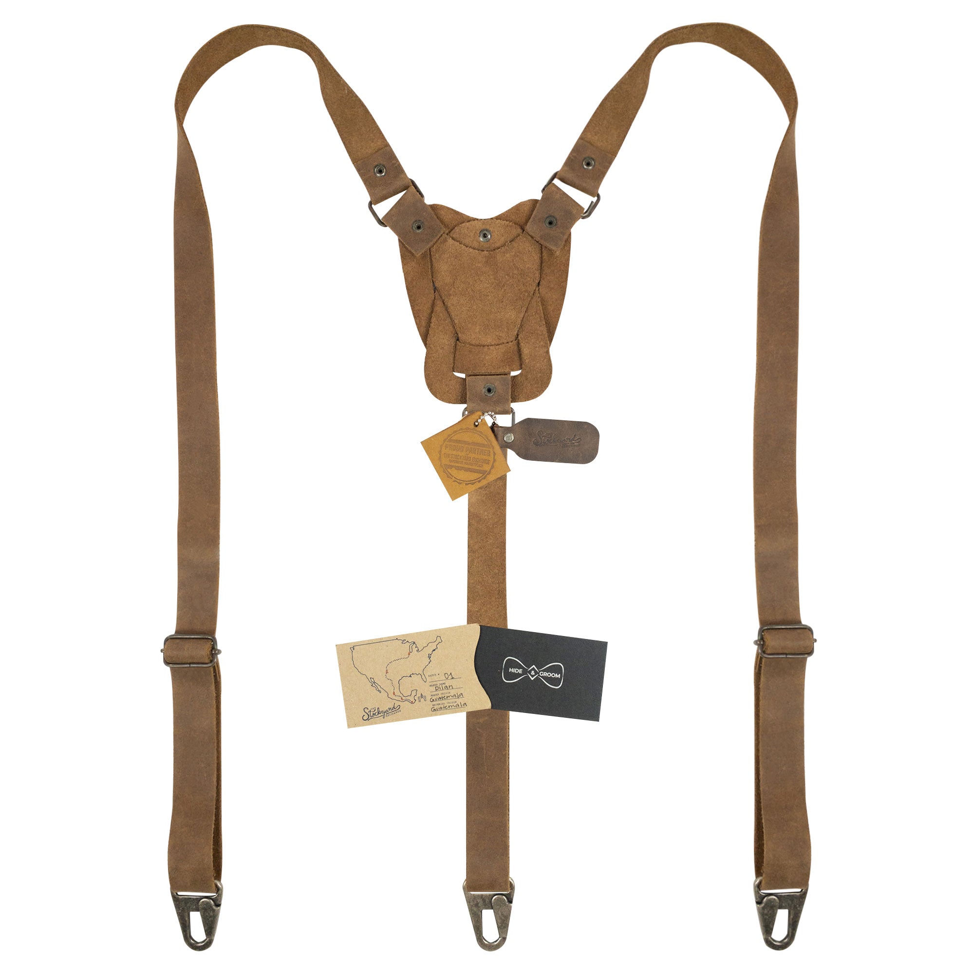 Rustic Suspenders with Adjustable Size Straps for Men by Hide & Groom, featuring a charming tag and card. Made from Full Grain Leather, these handcrafted suspenders are perfect for weddings and bring artisan flair to any Steampunk ensemble.