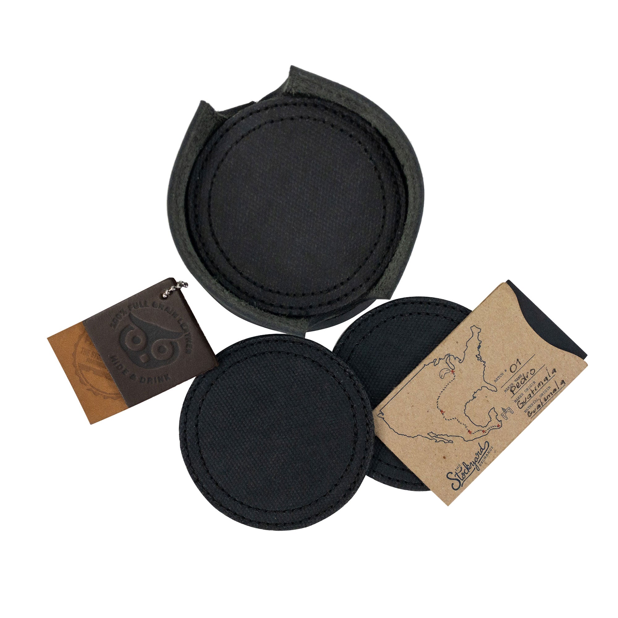Coasters with tags displayed from the Set of 8 Circular Coasters for Drinks by Hide & Drink. Designed to protect Glass & Cups from stains, this set is crafted from the finest Waxed Canvas and Full Grain Leather. Discover the quality of StockyardX and their Small Batch Production approach with these Hand Cut, Hand Sewn, Fire Branded coasters, made Artisan, Handmade in La Antigua Guatemala & Oaxaca Mexico.