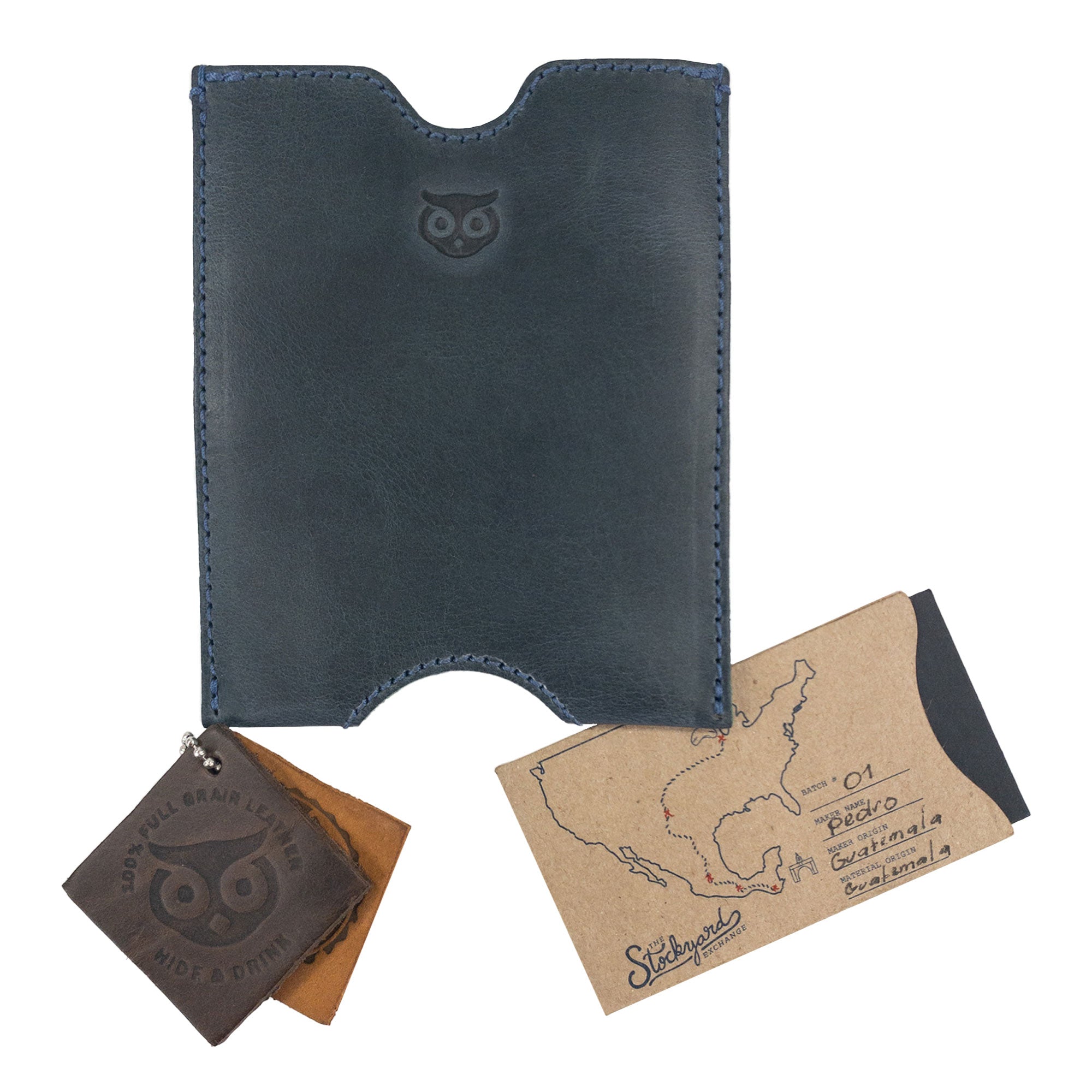 Hide & Drink Passport Sleeve displayed alongside leather tags, showcasing its artisan quality and unique design. This full grain leather travel passport pocket sleeve enhances your travel experience with elegance. Features tags: Travel Passport Pocket Sleeve, Full Grain Leather, StockyardX, Small Batch Production, Hand Cut, Hand Sewn, Fire Branded, Artisan, Handmade in La Antigua Guatemala & Oaxaca Mexico.
