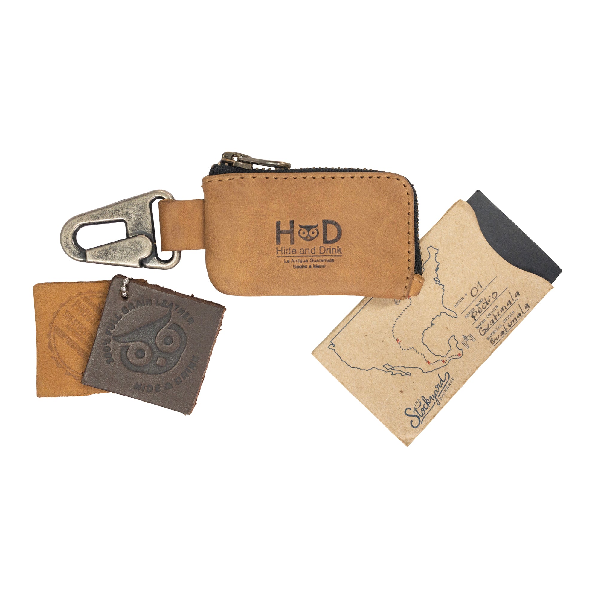 Car Key Holder by Hide & Drink, emphasizing its secure design for storing keys and cash while being useful for Headphone and charging Cables, Memory Cards, and Flash Drives. This functional accessory is crafted from durable Full Grain Leather and features a Nickel Metal Clasp, highlighting artisan craftsmanship from Small Batch Production in La Antigua Guatemala & Oaxaca Mexico.