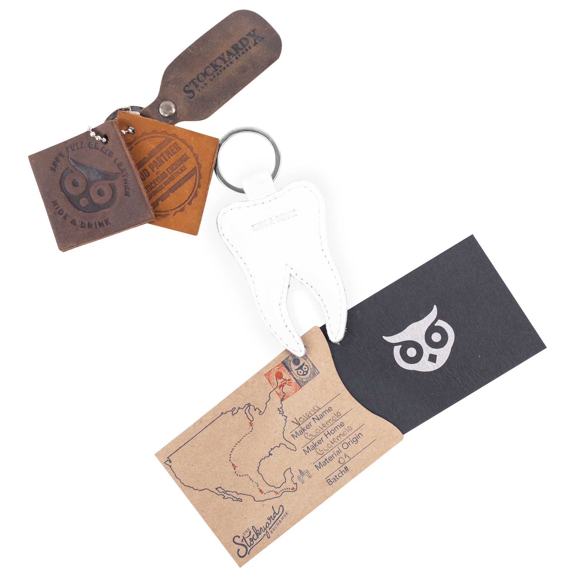 Presentation of the Tooth Keychain by Hide & Drink along with other artisan products. The Tooth Leather Keychain is a whimsical key ring made from full grain leather, showcasing what makes quality handmade gifts. Ideal for dentist gifts, it represents small batch production, hand cut, hand sewn, and is fire branded, lovingly crafted in La Antigua Guatemala & Oaxaca Mexico.