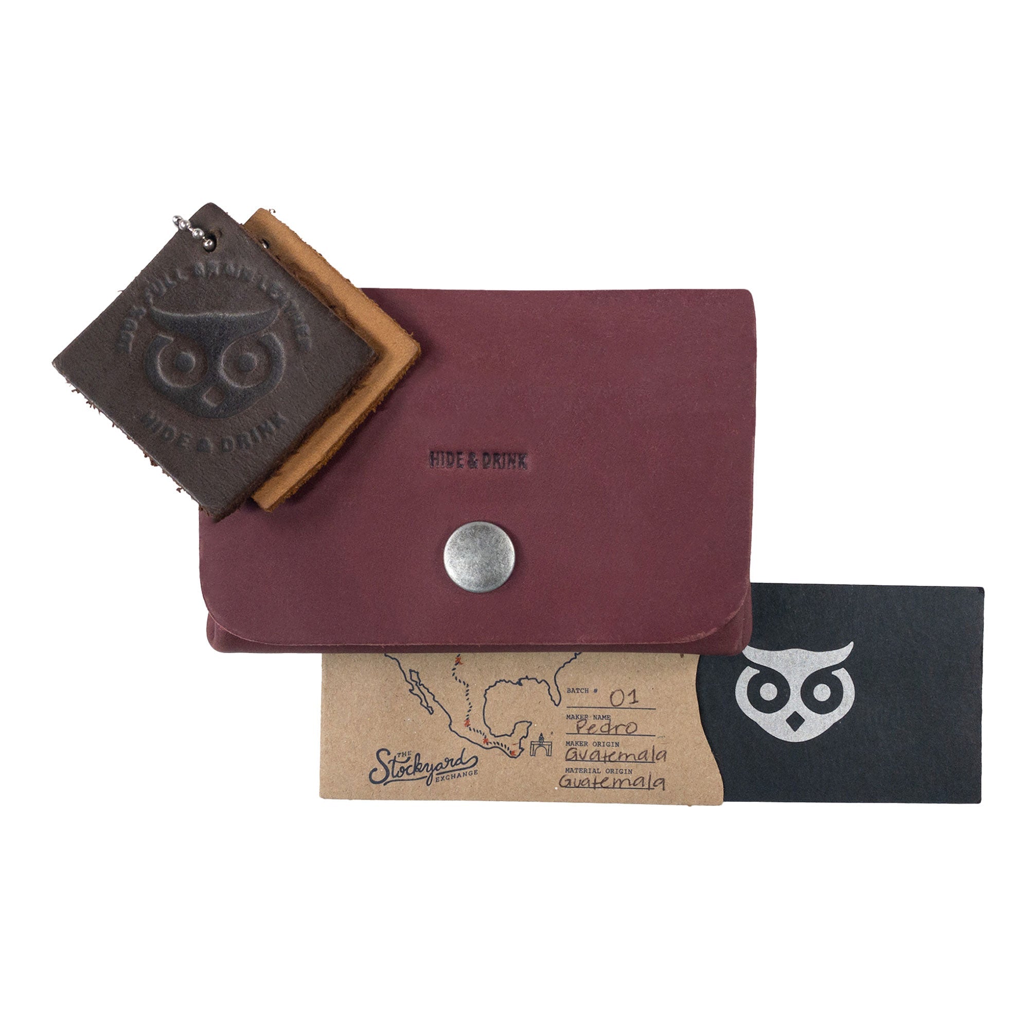 Display of the burgundy Double Pouch Card Wallet by Hide & Drink alongside other leather items. This Leather Double Pouch Card Wallet is designed for efficient use as a card organizer, cash holder, and ID case for both men and women, made with Full Grain Leather in La Antigua Guatemala & Oaxaca Mexico.