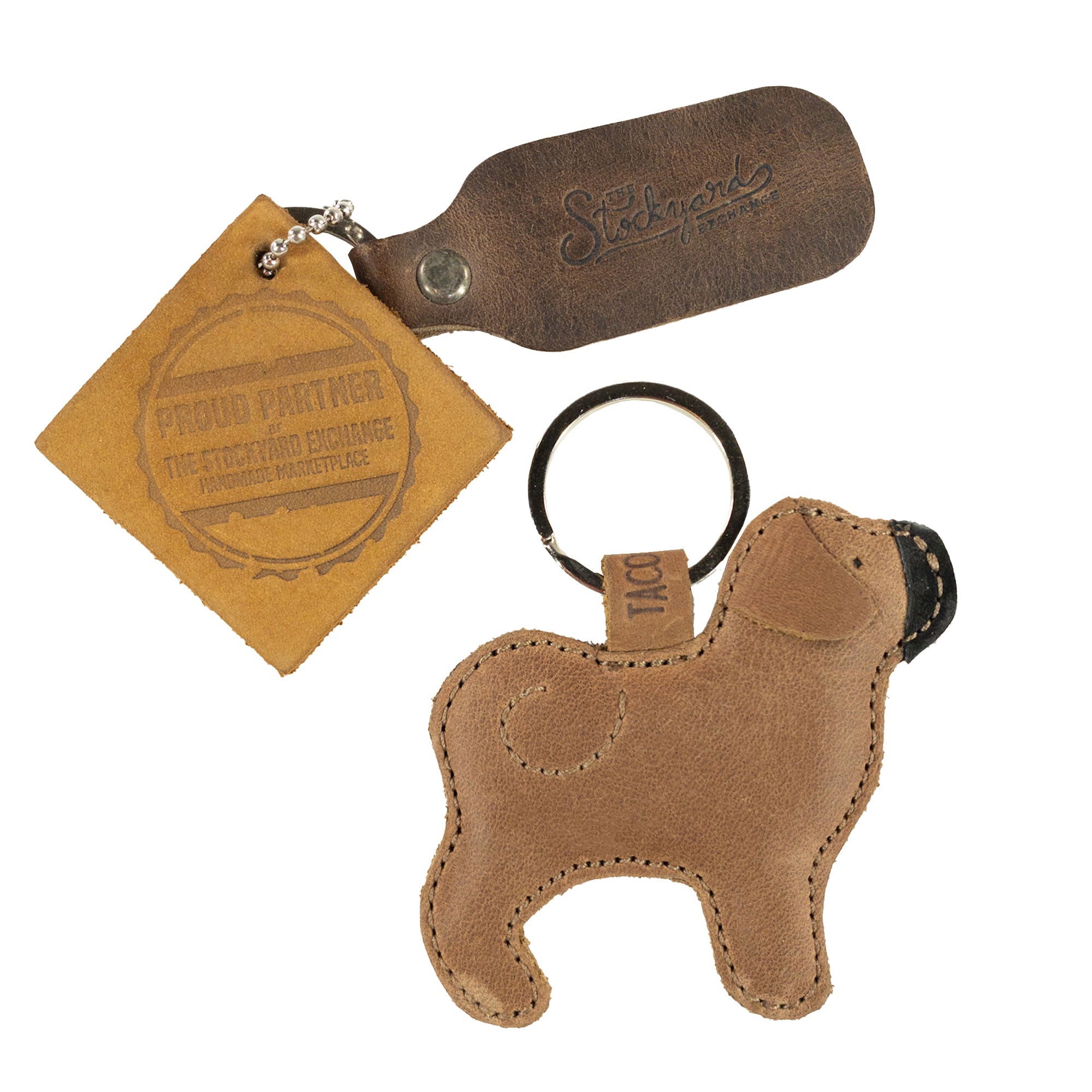 Pug Keychain from Taco Dog paired with a stylish tag, emphasizing its artisan quality. This charming keychain features a rustic design and is made from durable, all-natural full grain leather. Ideal for gifting, it combines functionality with lightweight comfort while showcasing handcrafted details from La Antigua Guatemala & Oaxaca Mexico.