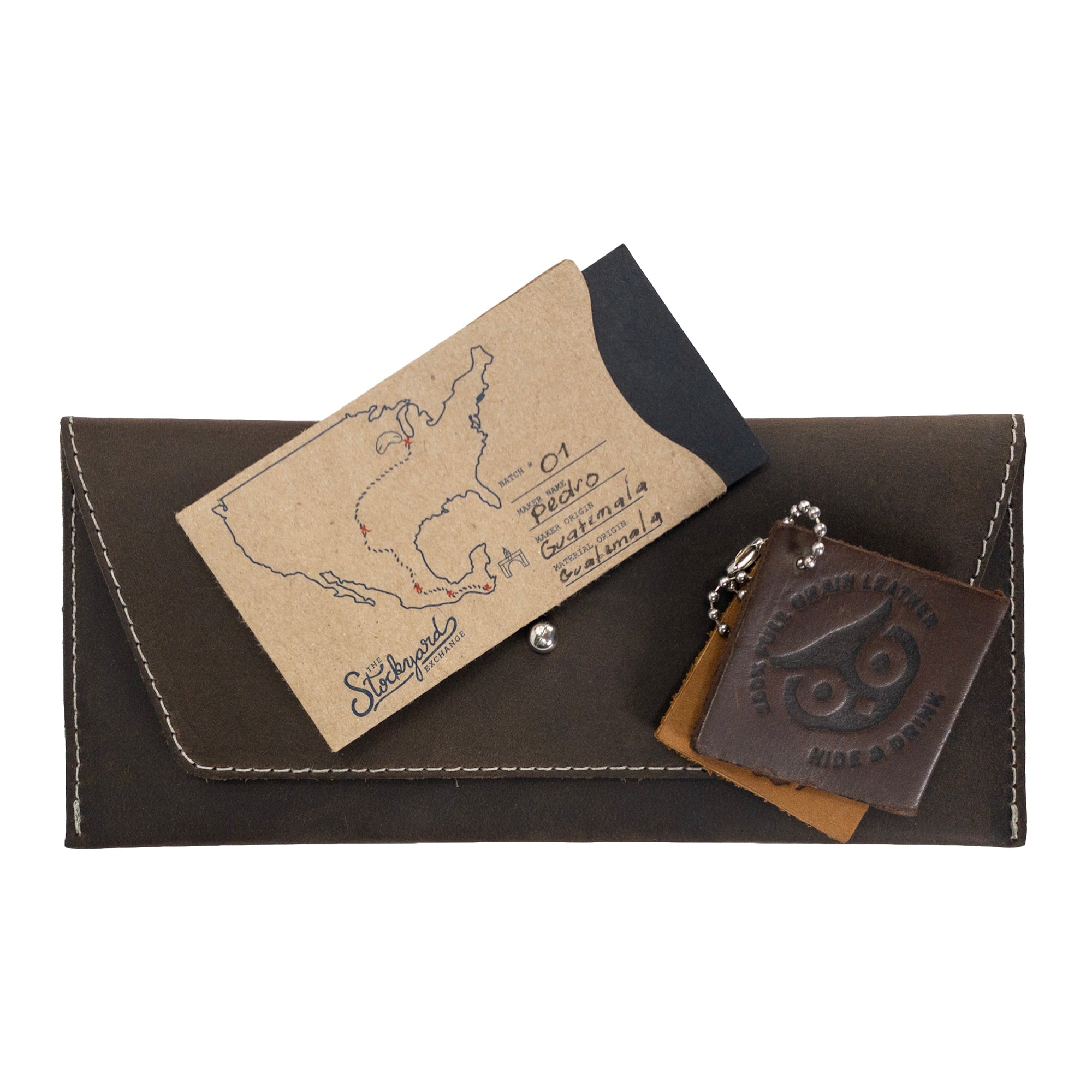 Presenting the Long Utility Pouch in brown leather from Hide & Drink, displayed with a gift card, perfect for gifting. A stylish accessory for everyday essentials.