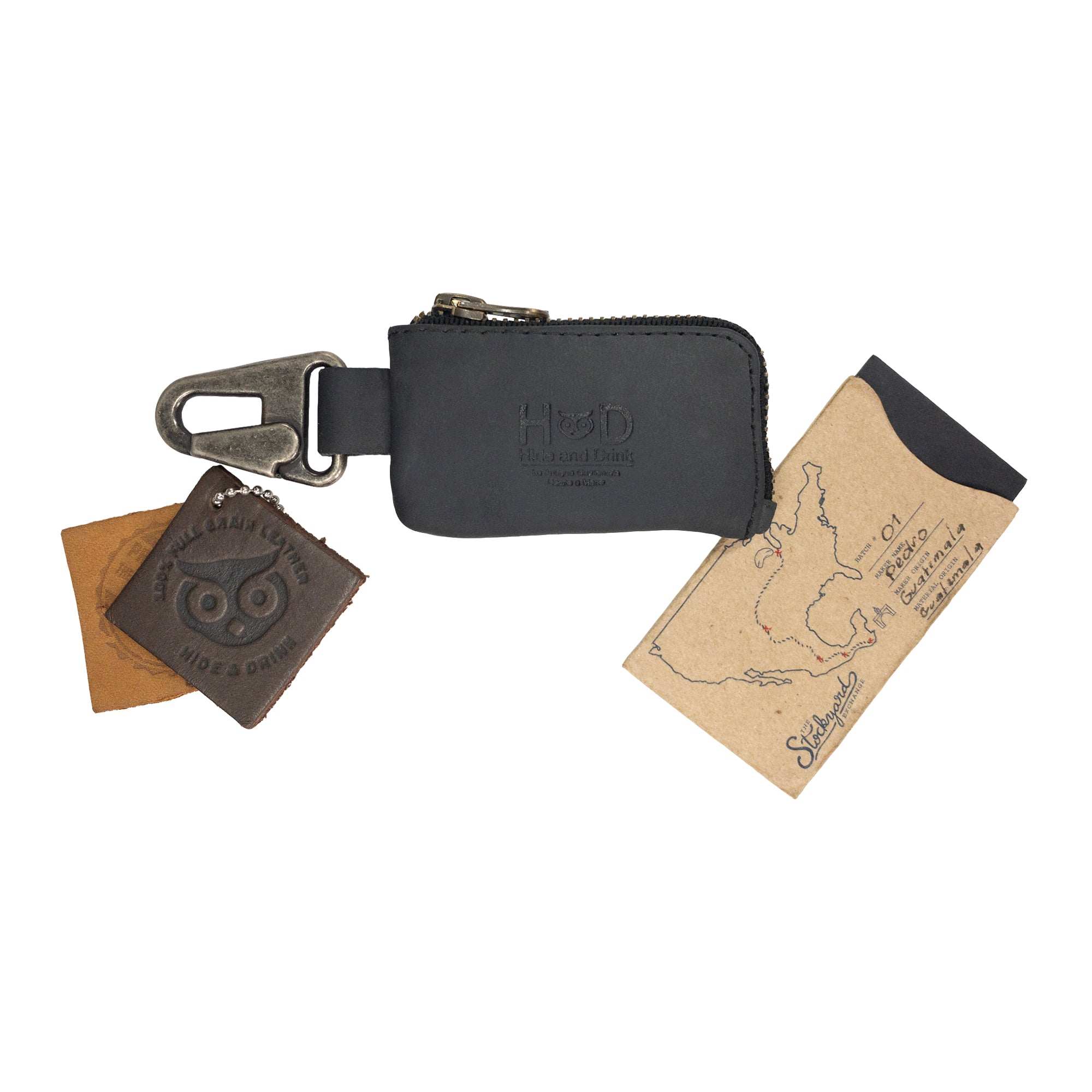 A stylish Car Key Holder from Hide & Drink, showcasing a cash zipper case with a nickel metal clasp made of full grain leather. Perfect for keyless entry cars and storing headphone and charging cables, memory cards, flash drives, and cash. Artisan crafted in La Antigua Guatemala & Oaxaca Mexico.