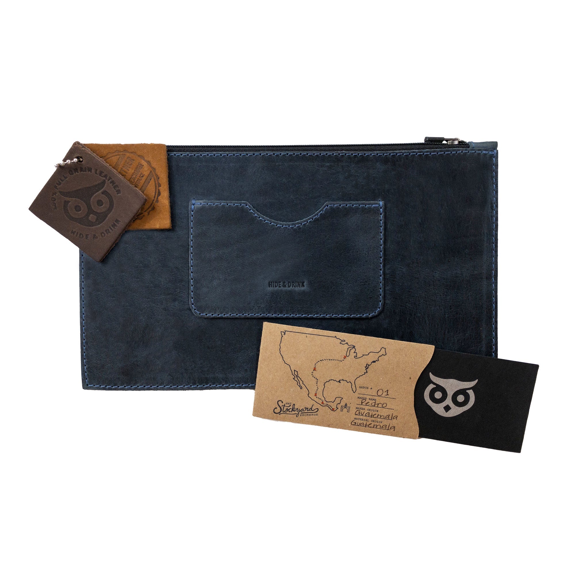 Size comparison of a dark brown rectangular zippered handbag by Hide & Drink next to an iPhone, illustrating its size. This well-designed female purse features a card slot and is crafted from full grain leather, showcasing artisan craftsmanship through dedicated small batch production methods, handmade in La Antigua Guatemala & Oaxaca Mexico.