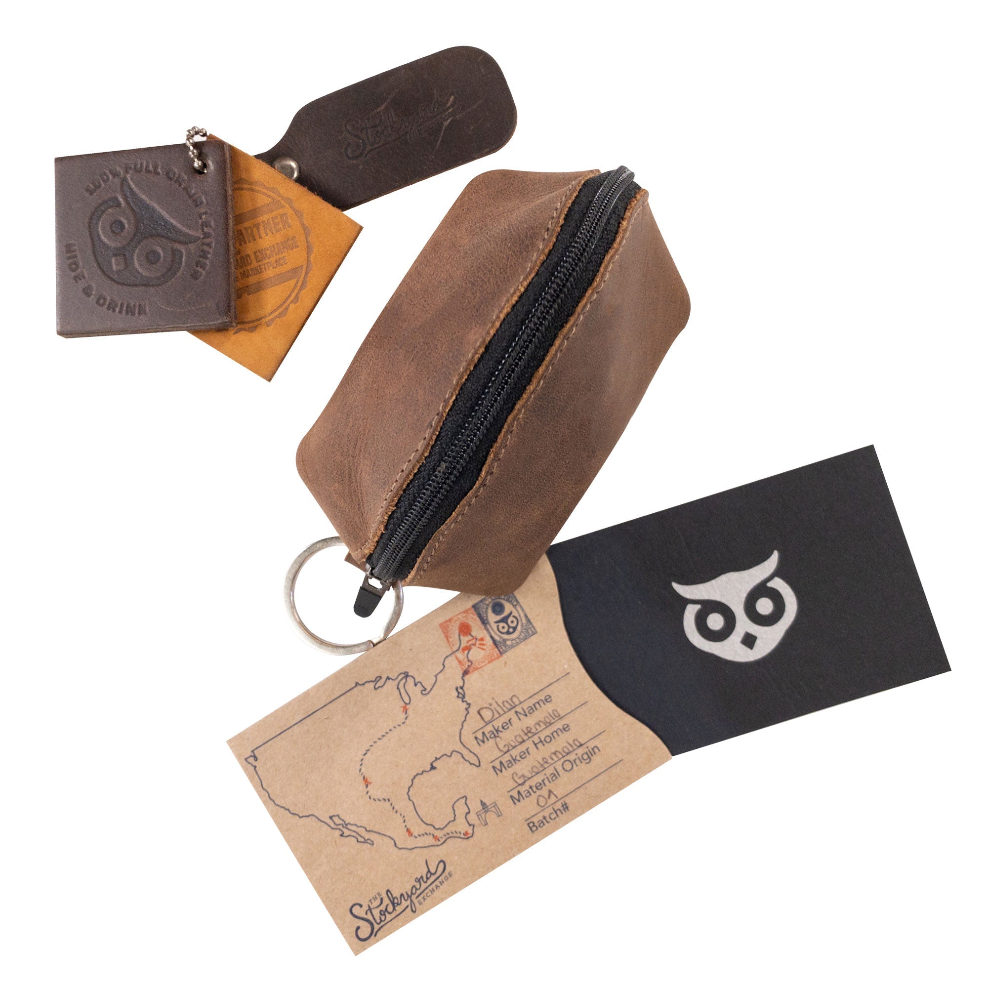 Hide & Drink’s Keychain Coin Pouch alongside branding elements and a care tag, emphasizing its handcrafted quality. Coin Pouch, Keychain, Wallet, Purse, Holder, SD Card, USB, Cash, Case, made of Full Grain Leather, handmade in La Antigua Guatemala & Oaxaca Mexico.