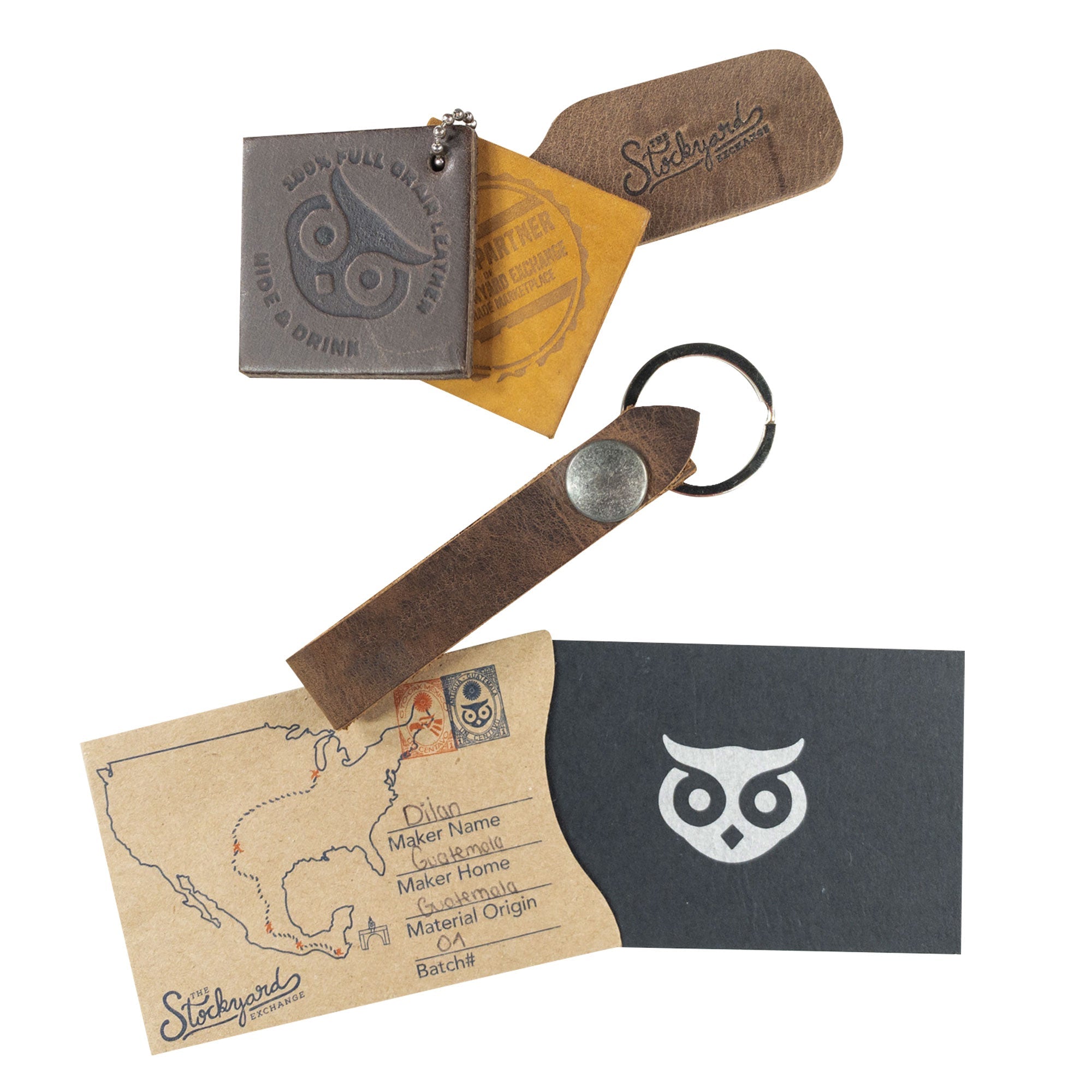 Hide & Drink Loop Keychain presented with business cards and tags, featuring a rustic design. This keyring organizer, made from full grain leather, represents the artisan techniques of small batch production in La Antigua Guatemala & Oaxaca Mexico.