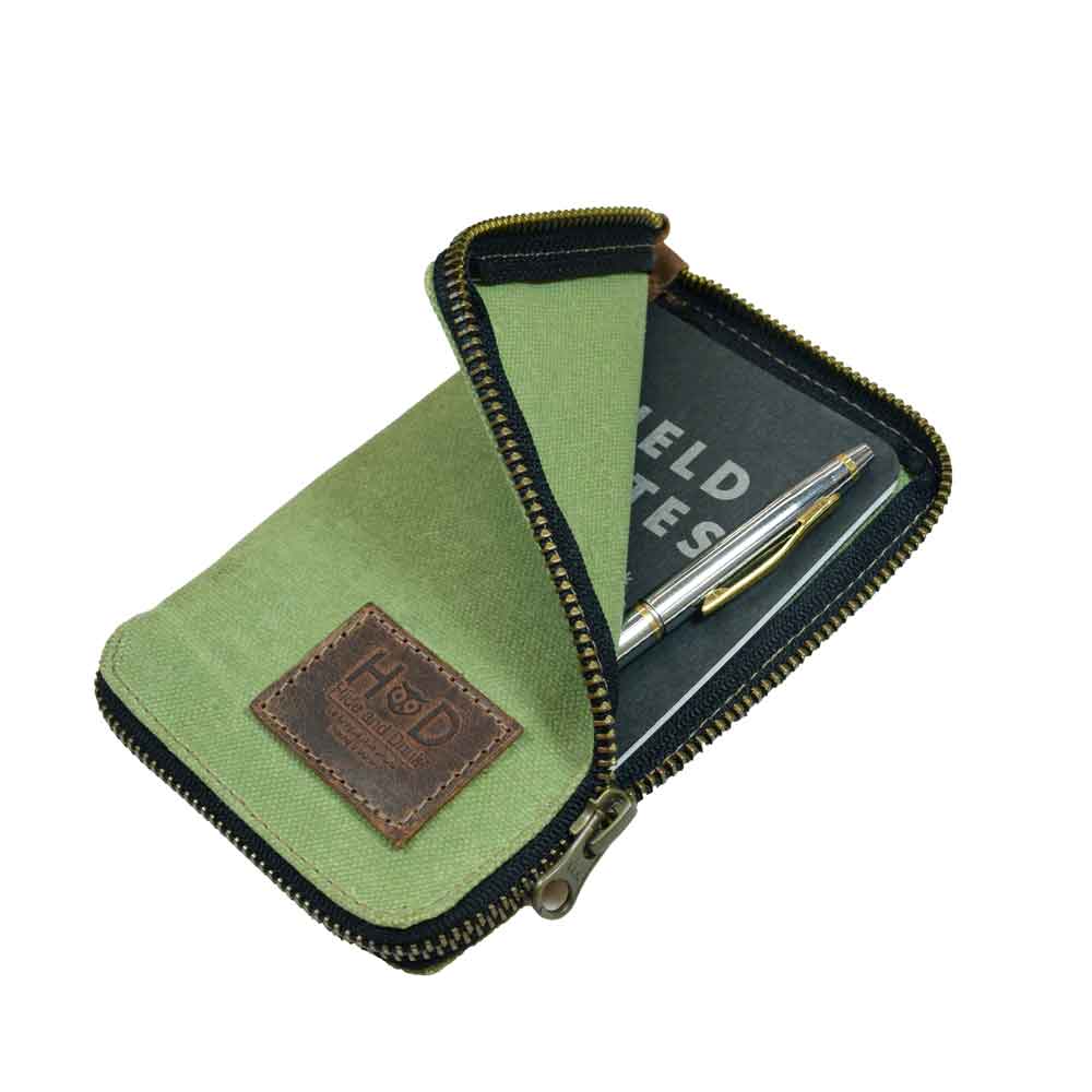 Open view of the Waxed Canvas Zippered Journal Cover for Moleskine (Notebook NOT Included) by Hide & Drink, emphasizing its spacious design for notes. Perfect for Cahier Cases, integrating Full Grain Leather and artisan craftsmanship from La Antigua Guatemala & Oaxaca Mexico.