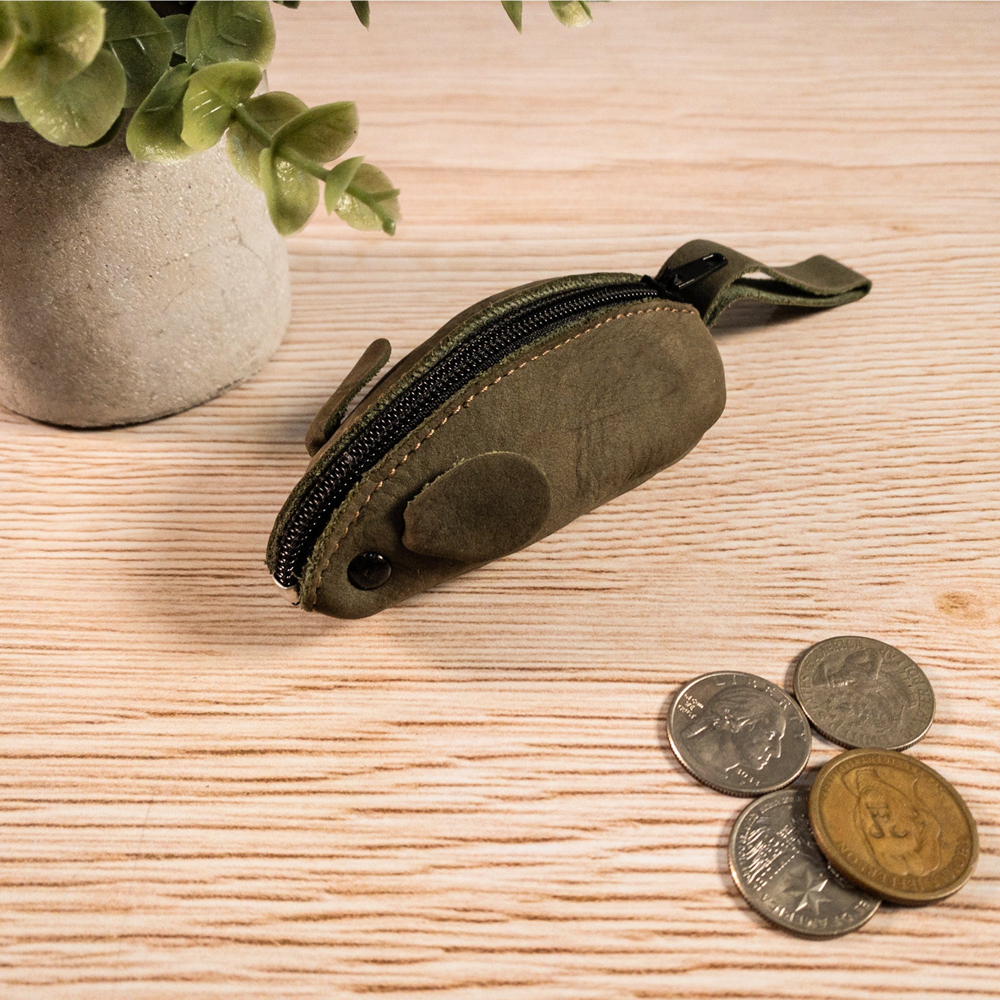 Hide & Drink Mouse Coin Pouch on display, showcasing its playful design. This Mouse-Shaped Coin Pouch is a charming Change Pouch and handy Pocket Case for Coins, made of premium Full Grain Leather for any travel accessory needs.