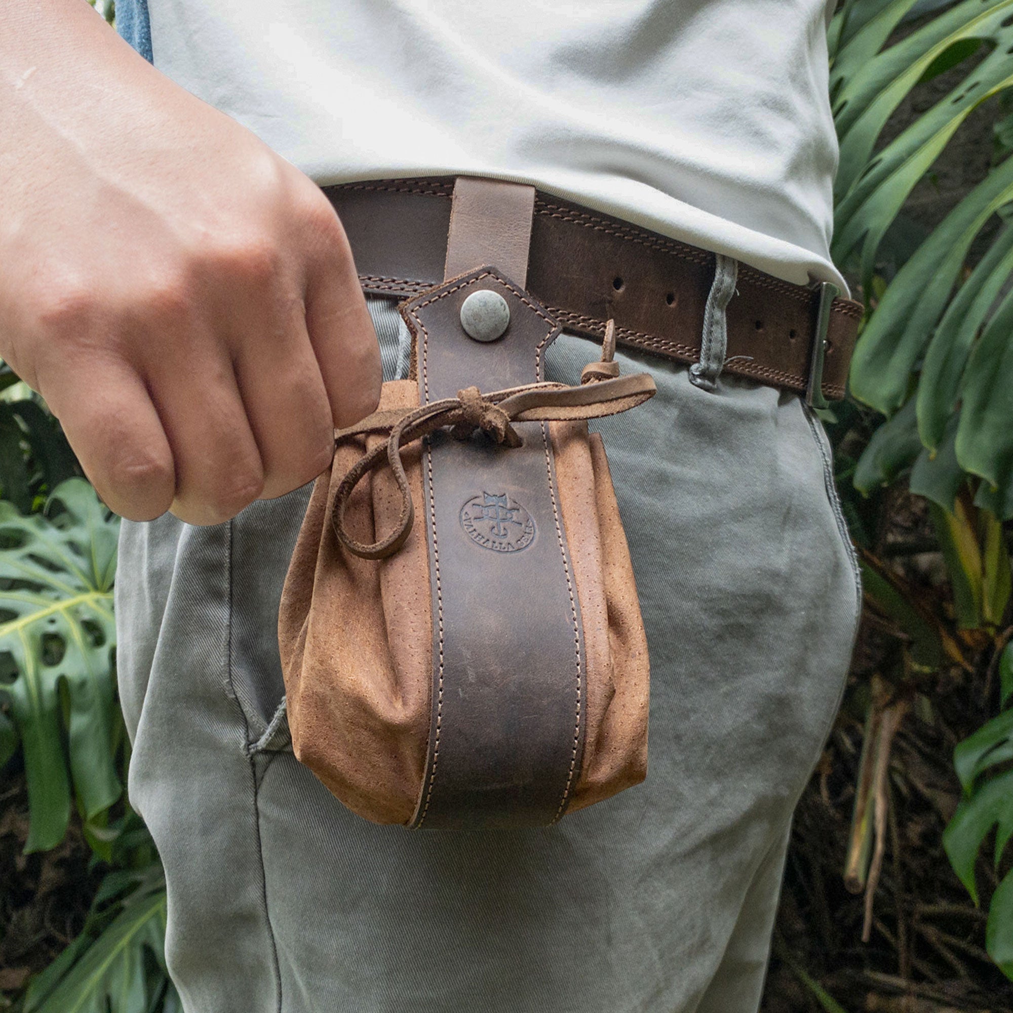 A person wearing the Medieval Drawstring Pouch by Valhalla Gear on their belt, demonstrating utility and style, crafted from durable Full Grain Leather, hand cut and sewn by artisans.