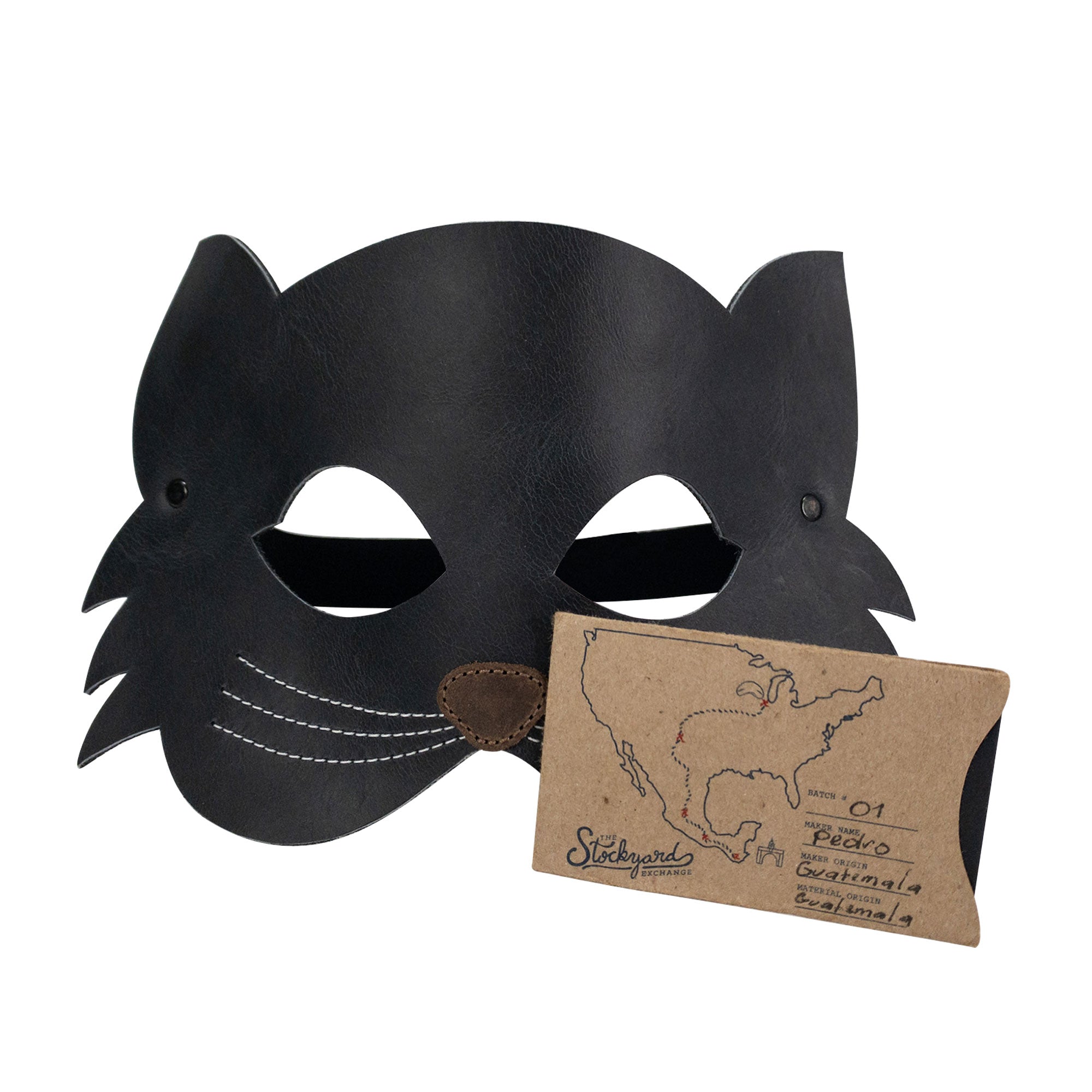 The Cat Shape Face Mask by Hide & Play displayed alongside a card, emphasizing its handmade nature and attention to detail. Made from full grain leather, this artisan accessory showcases the craftsmanship of La Antigua Guatemala, ideal for cat lovers and those seeking custom accessories.