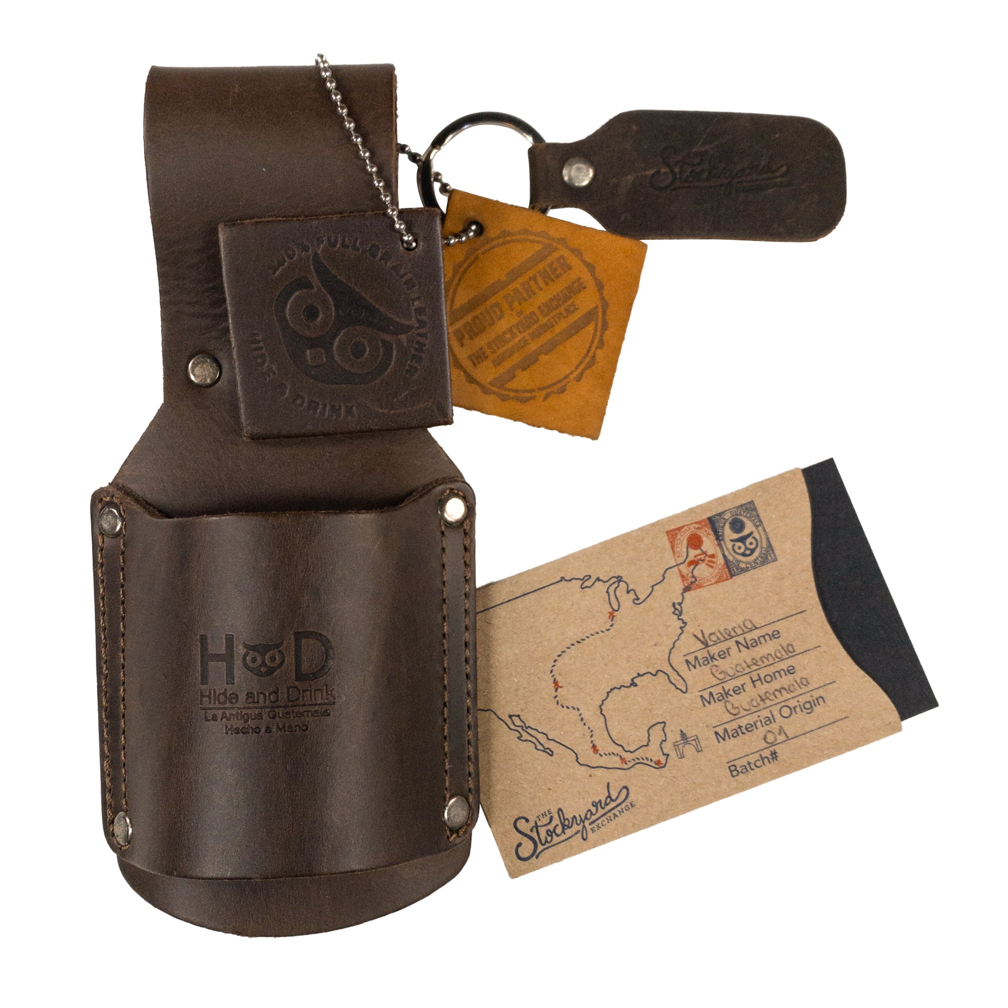 Complete set including Hammer Holster by Hide & Drink along with care tag, representing quality craftsmanship for electricians and construction professionals. Made from Full Grain Leather, this handmade organizer ensures tools are always on hand. Hammer Holster - Electrician & Construction, Tool Holder, Organizer, Sheath, Case, Woodwork & Handcraft, Full Grain Leather, StockyardX, Small Batch Production, Hand Cut, Hand Sewn, Fire Branded, Artisan, Handmade in La Antigua Guatemala & Oaxaca Mexico.