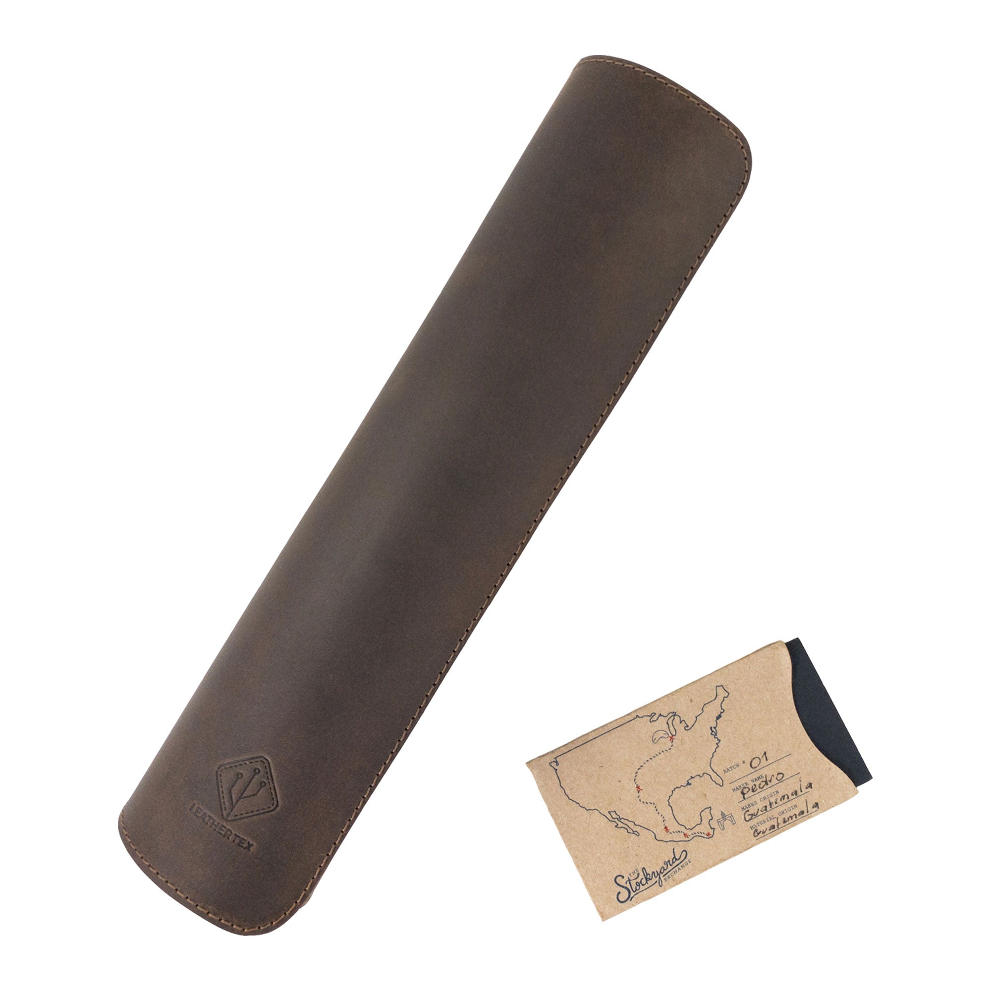 An elegant 34 Inch Long Desk Pad for Keyboard, Mouse, and Cellphone by LeatherTex alongside a leather pen case. Both items feature full grain leather and represent small batch production with hand cut and hand sewn techniques, capturing the artistry of craftsmen in La Antigua Guatemala & Oaxaca Mexico.
