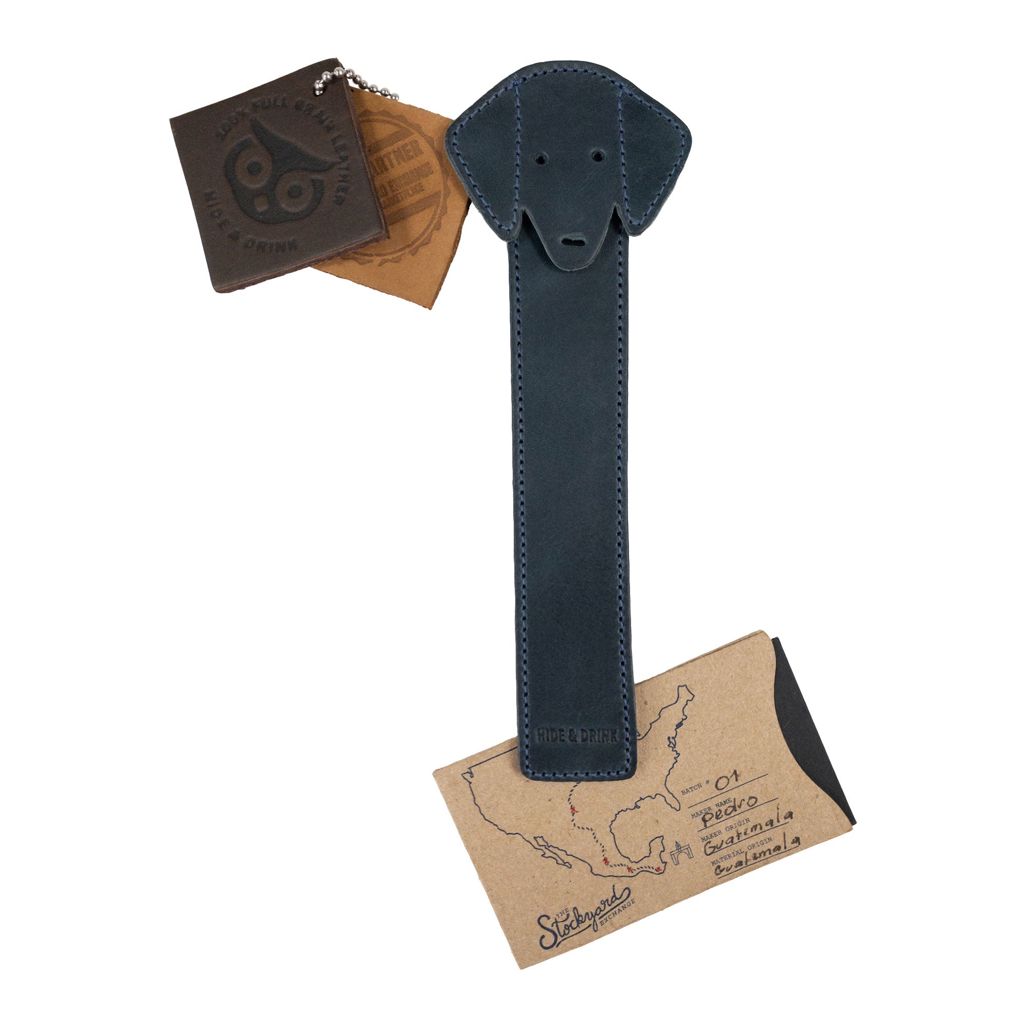 Hide & Drink's navy Dog Bookmark with packaging, illustrating its quality Full Grain Leather material. This artisan bookmark celebrates small batch production and fire branding, proud of its roots in La Antigua Guatemala & Oaxaca Mexico.