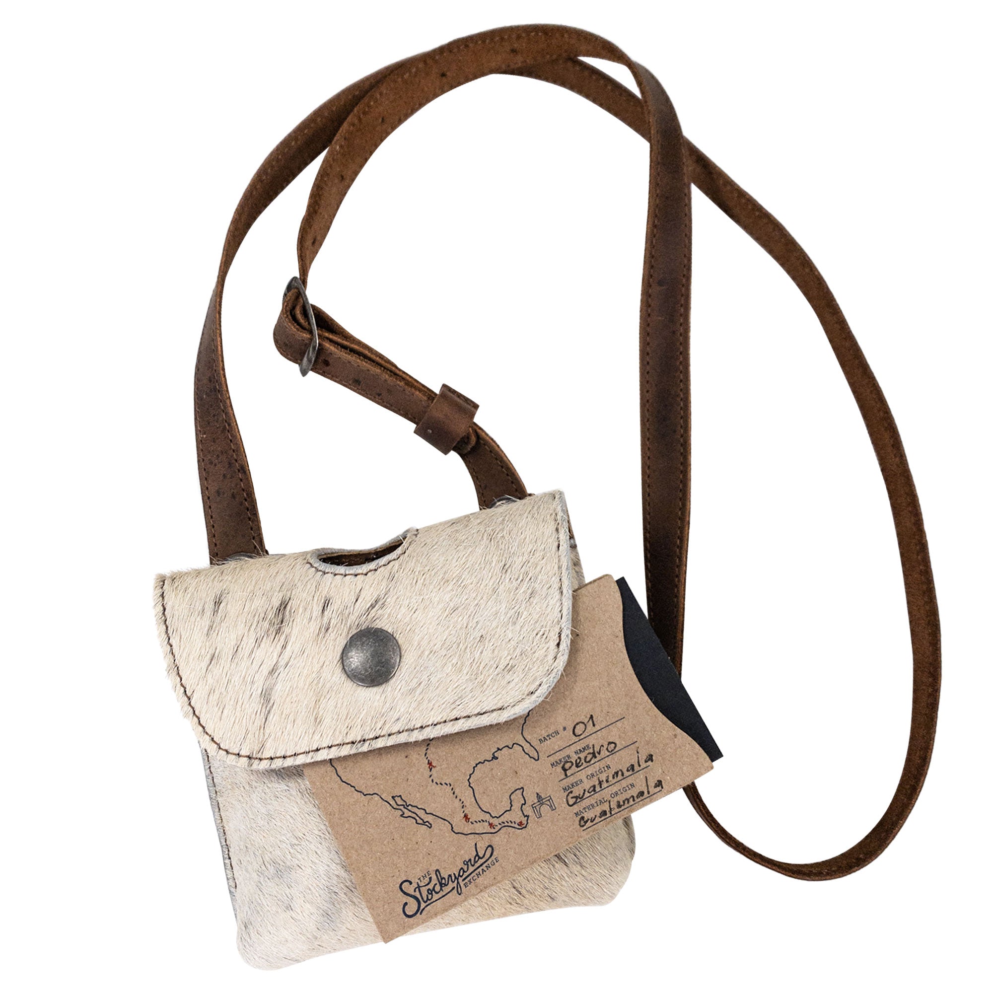 A side view of the Western Leather Works Liquor Flask Holder, showcasing its exquisite Hair On Hide Full Grain Leather texture. This piece is perfect for anyone seeking style and functionality, though the bottle is not included. Revel in the craftsmanship of small batch production, hand cut and hand sewn features, and fire branding, highlighting the handmade quality from La Antigua Guatemala & Oaxaca Mexico.