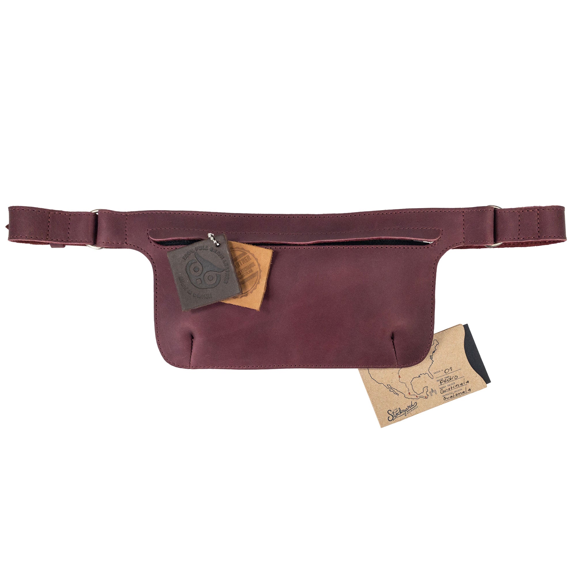 Slim Fanny Pack by Hide & Drink displaying a vibrant maroon shade with a compact design, ideal for daily use. This narrow waist bag is crafted from full grain leather and showcases the quality of artisan craftsmanship.