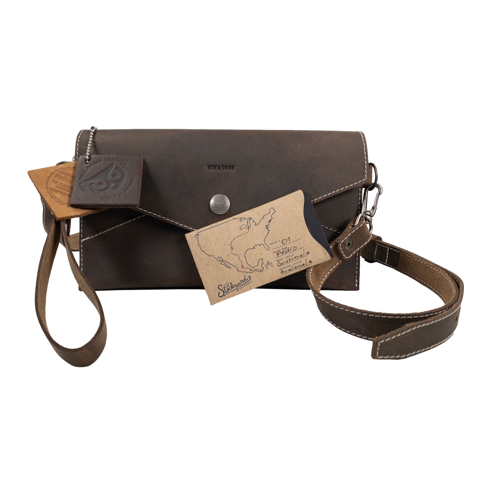 Convertible Envelope Bag by Hide & Drink with additional tags, designed in elegant Full Grain Leather. This Envelope Crossbody Bag emphasizes small batch production and artisan craftsmanship with meticulous hand cut and hand sewn construction made in La Antigua Guatemala & Oaxaca Mexico.