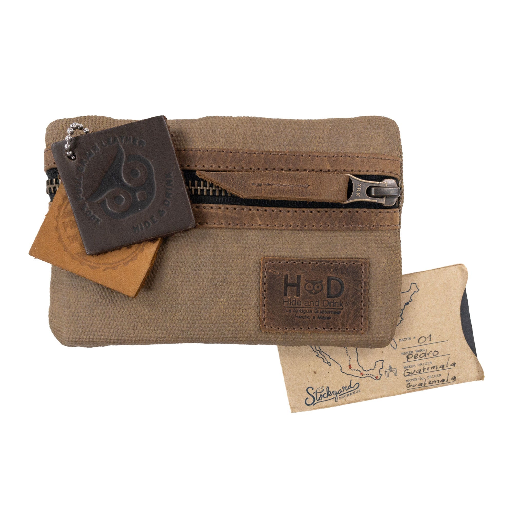 Multi-tool Pocket Pouch by Hide & Drink presented with tags showcasing its artisanal production, made from durable waxed canvas and full grain leather, ideal for small batch production.