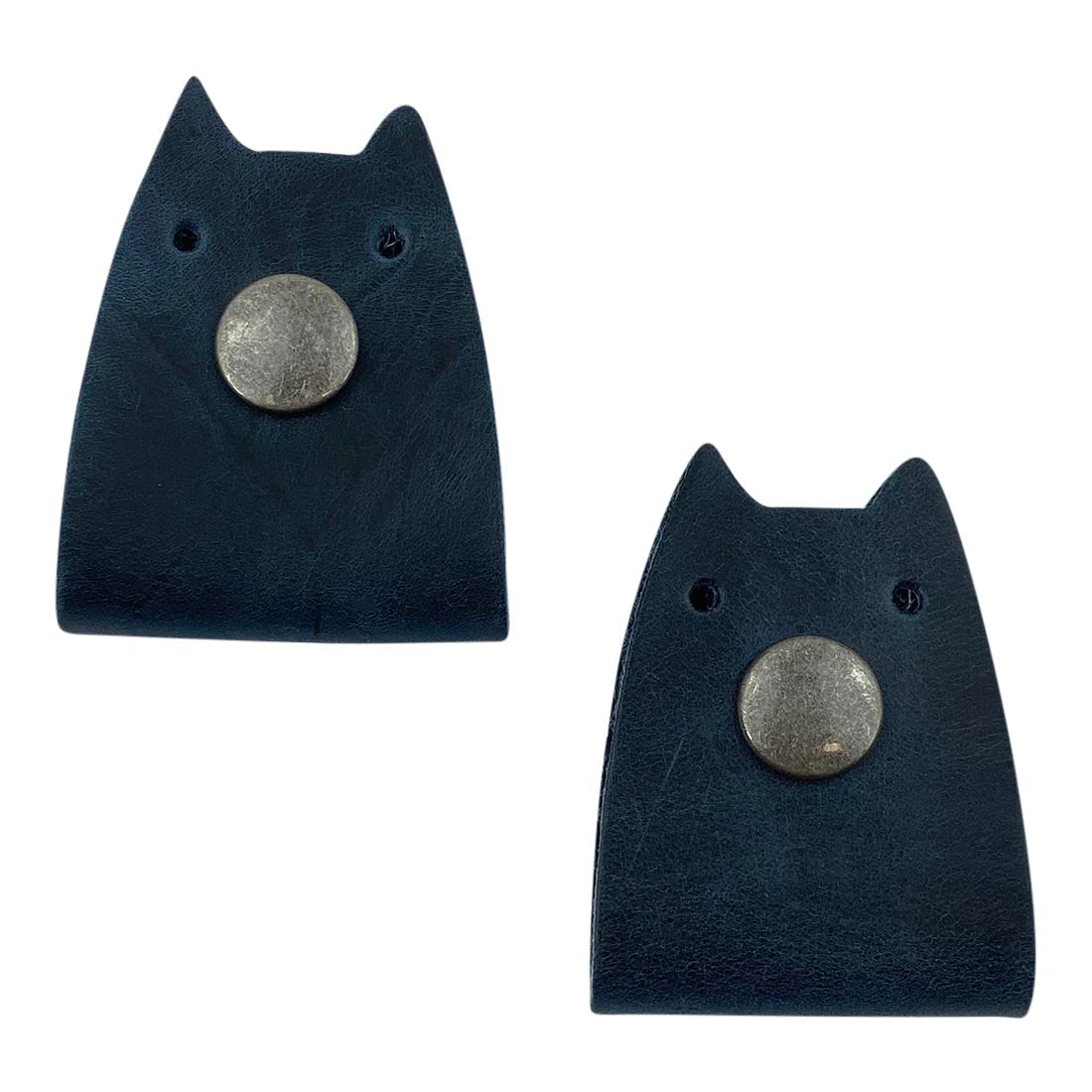 Taco Dog's Cat Cord Keeper (2 Pack) in navy leather, designed for efficient cable management. The stylish leather keeps earbuds, headphones, and chargers neatly organized while traveling. Handmade in La Antigua Guatemala & Oaxaca Mexico.