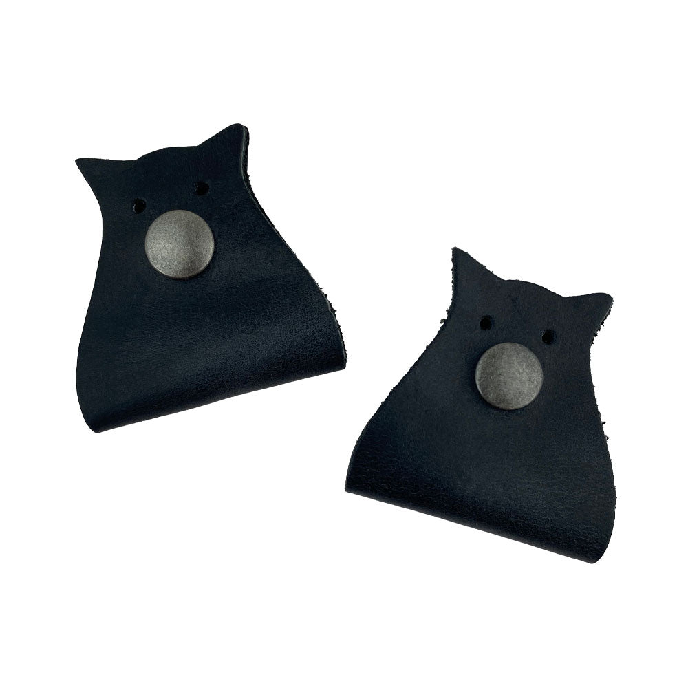 Charming Owl Shaped Cord Keeper (2-Pack) by Hide & Drink showcasing the sleek black leather finish, perfect for stylish cord organization. Owl Shaped Cord Keeper (Cord Clam) 2-Pack. Full Grain Leather, StockyardX, Small Batch Production, Hand Cut, Hand Sewn, Fire Branded, Artisan, Handmade in La Antigua Guatemala & Oaxaca Mexico.