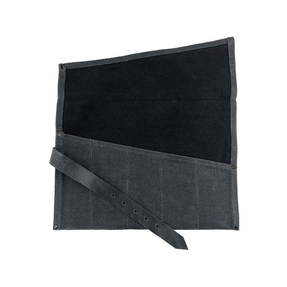 A beautifully presented Large Tool Roll by Hide & Drink, ready for artisans' tools. This Portable Carry-On Pouch features 6 slots for organization of woodworking tools. Constructed from waxed canvas and full grain leather variations, this artisan product highlights the dedication to small batch craftsmanship, hand cut and hand sewn in La Antigua Guatemala & Oaxaca Mexico.