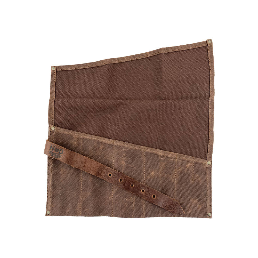 A stylish Large Tool Roll from Hide & Drink designed for convenient use. This Portable Carry-On Pouch features 6 slots for organizing woodworking tools easily. Constructed using waxed canvas and full grain leather variations, this artisan piece highlights meticulous hand-cut and hand-sewn craftsmanship, proudly made in La Antigua Guatemala & Oaxaca Mexico.