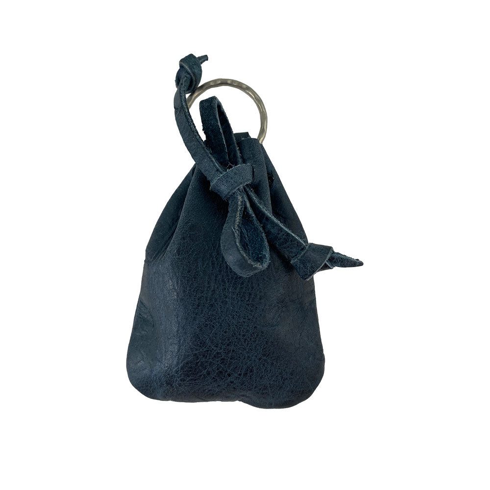 A chic Mini Medieval Pouch Keychain from Hide & Drink in navy leather, designed as a tiny bag with keyring. This versatile coin pouch highlights full grain leather quality and exemplary artisan craftsmanship with hand-cut and hand-sewn details from La Antigua Guatemala.