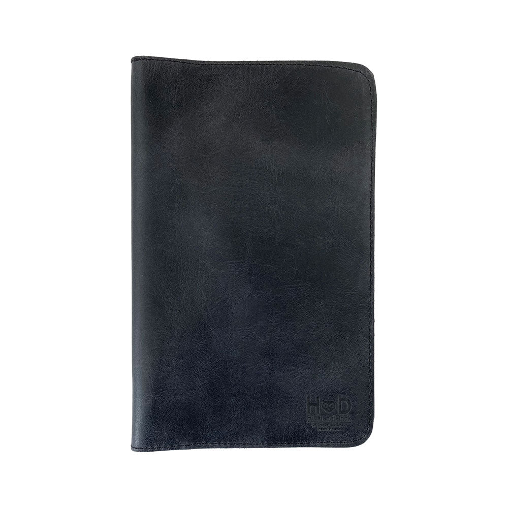 Front view of a black Journal Cover for Moleskine Cahier L (5 x 8.25 in.) by Hide & Drink. This refillable leather cover is perfect for large size (5 x 8.25 in.) notebooks, showcasing its handmade rustic charm and artisan craftsmanship.