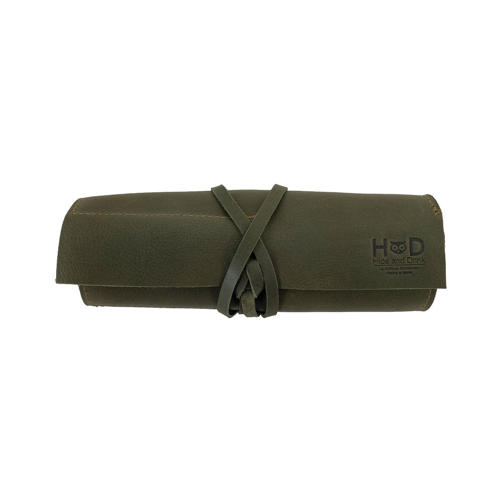 Hide & Drink Multi Purpose Pencil Roll in a display showcasing its versatile features and sturdy leather craftsmanship. This handmade organizer is perfect for storing scissors, earphones, and more, combining functionality with rustic style.