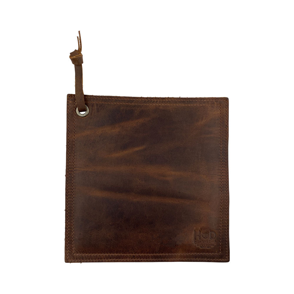 Hide & Drink Pot Pad in a rich dark brown leather finish, showcasing its handcrafted quality. This rustic hot pot pad is double-layered and designed for durability. Artisan made in La Antigua Guatemala & Oaxaca Mexico.