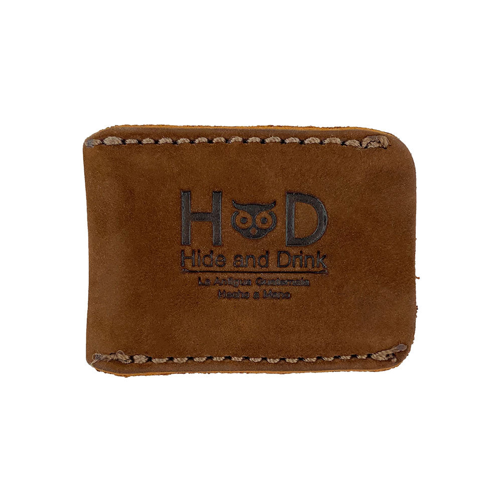 Razor Head Cover by Hide & Drink, showcasing the artisan logo on a beautifully crafted Full Grain Leather surface. This shaving travel cover fits over double sided razors and emphasizes the small batch production, hand cut and hand sewn processes, fire branded for authenticity, handmade in La Antigua Guatemala & Oaxaca Mexico.
