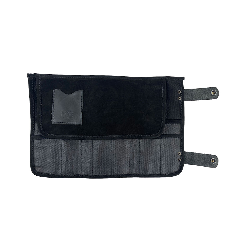Hide & Drink's Barber Tool Roll displays a Snap Tool Roll Up Bag with 14 Slots designed specifically for scissors & screwdrivers. Made from durable Full Grain Leather, this portable carry case highlights StockyardX's small batch production, artisan craftsmanship, hand cut, hand sewn, and fire branded in La Antigua Guatemala & Oaxaca Mexico.