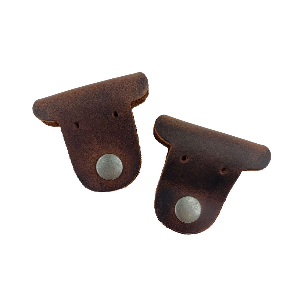 Two dark brown Dog Shaped Cord Keepers by Hide & Drink, crafted from Full Grain Leather, perfect for managing cords in style. Dog Shaped Cord Keeper (Cord Clam) 2-Pack, Full Grain Leather, StockyardX, Small Batch Production, Hand Cut, Hand Sewn, Fire Branded, Artisan, Handmade in La Antigua Guatemala & Oaxaca Mexico.