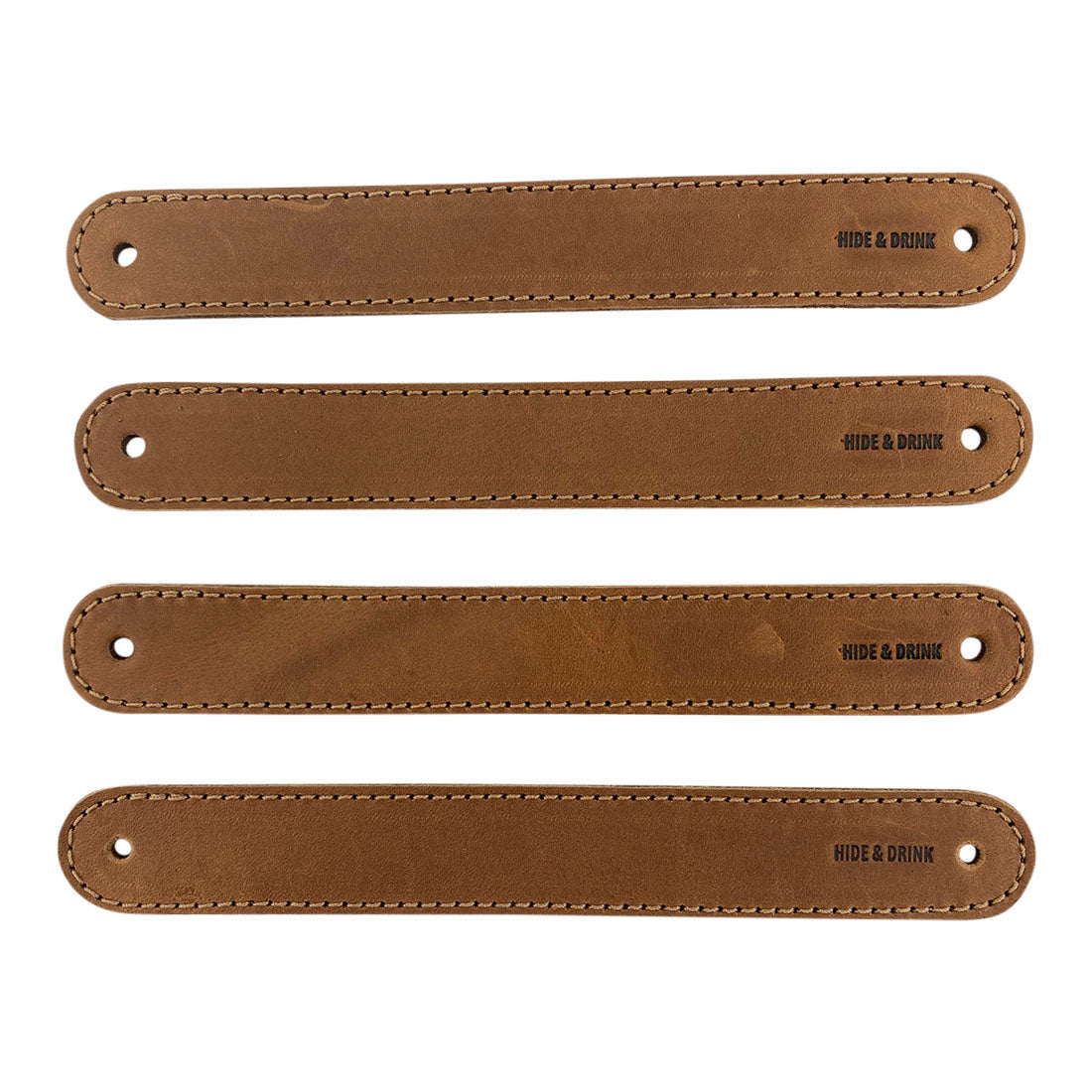 Hide & Drink Drawer Handles (4pk) featuring a close-up of light-colored leather handles, perfect for DIY projects. Durable, versatile, and artisan crafted with pre-made holes for easy installation.