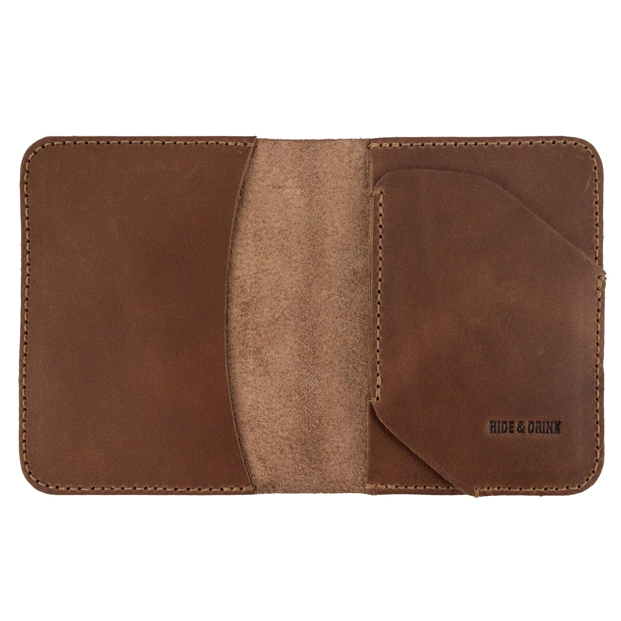 Open view of the Bi-Fold Card Wallet Diagonal by Hide & Drink in brown leather, showcasing its functionality and minimalist design for organization of cards and folded bills.