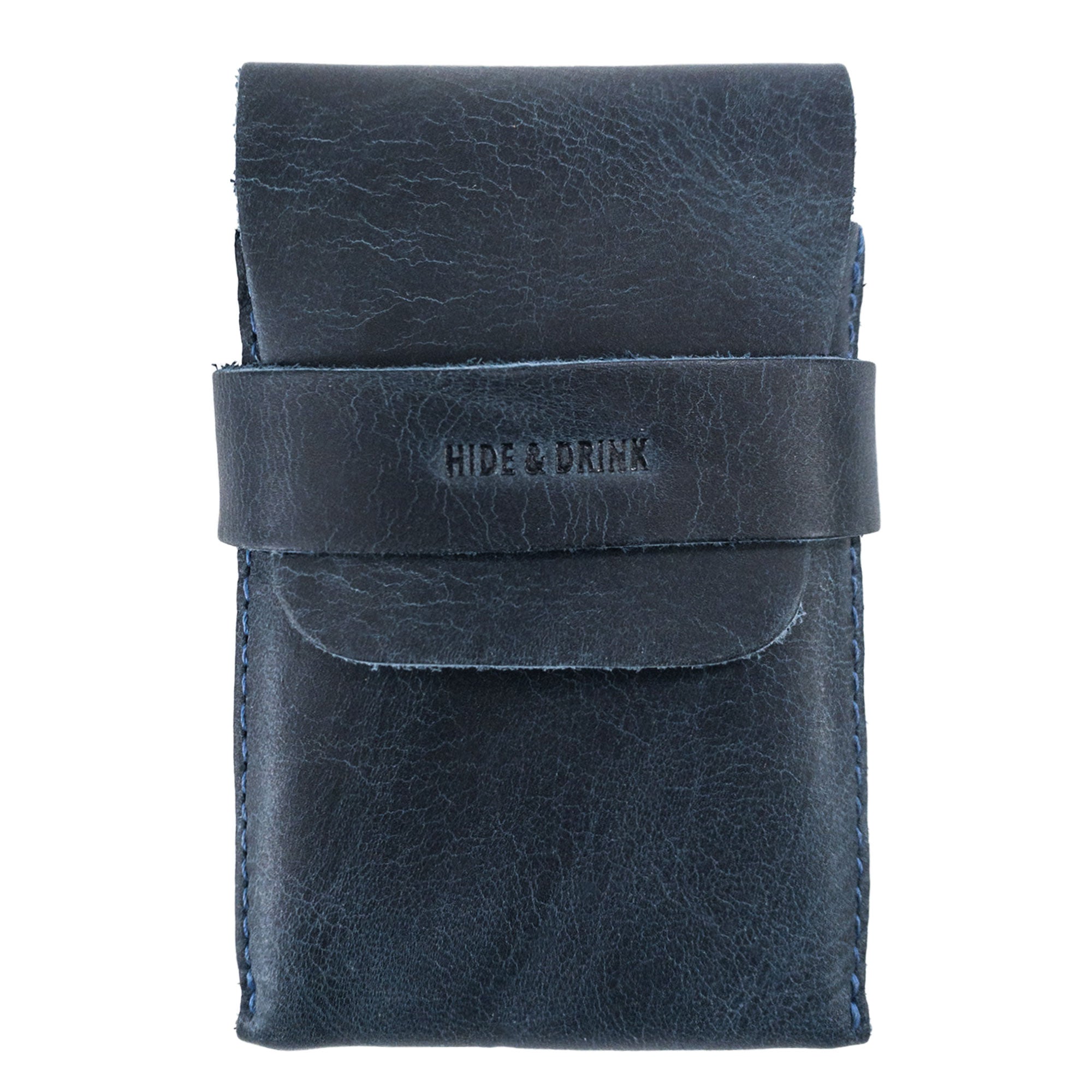 Front view of Hide & Drink's navy Playing Card Case, perfect for adventures. This stylish travel accessory secures your classic case for playing cards (not included) in its durable full grain leather. Handcrafted with artisan skill from StockyardX, it reflects high-quality craftsmanship.