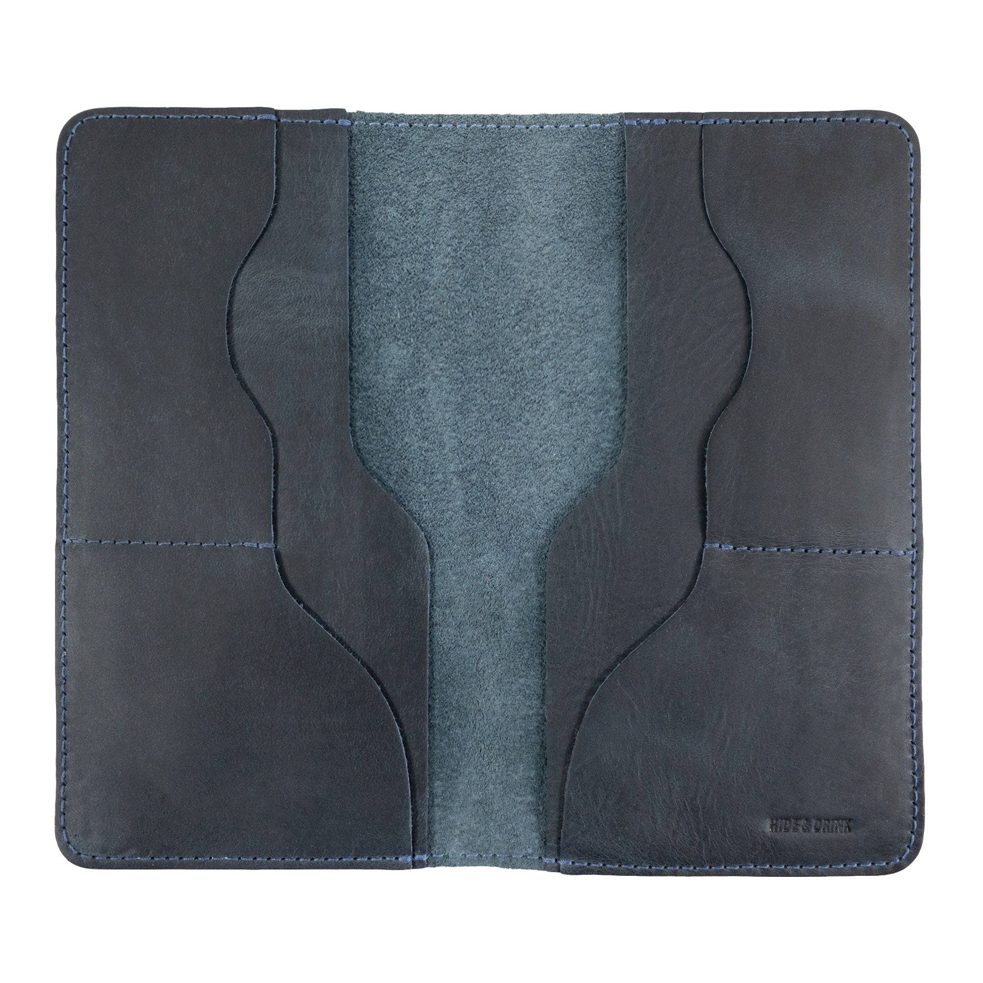Hide & Drink Large Organizer Wallet closed, displaying the beauty of full grain leather. This handmade bifold wallet offers card slots and a flat money holder, a perfect travel accessory made by local artisans in La Antigua Guatemala & Oaxaca Mexico.