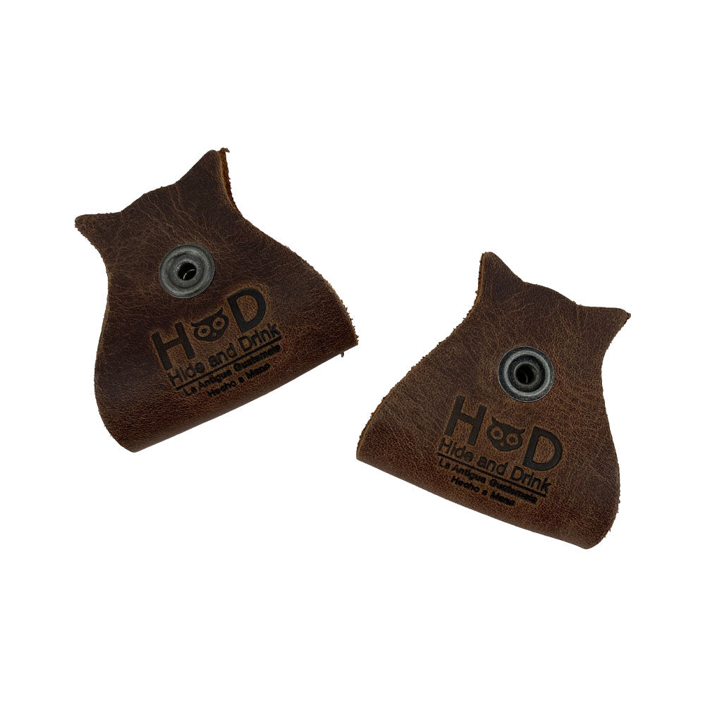 Charming Owl Shaped Cord Keeper (2-Pack) by Hide & Drink showcasing two well-crafted organizers in rich leather for effective cable management. Owl Shaped Cord Keeper (Cord Clam) 2-Pack. Full Grain Leather, StockyardX, Small Batch Production, Hand Cut, Hand Sewn, Fire Branded, Artisan, Handmade in La Antigua Guatemala & Oaxaca Mexico.