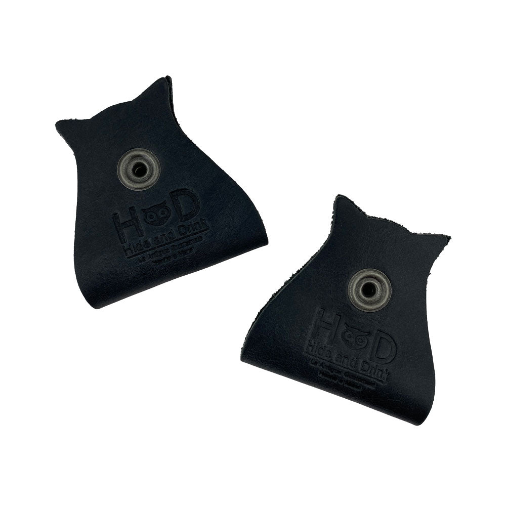 Stylish Owl Shaped Cord Keeper (2-Pack) by Hide & Drink featuring two beautifully crafted black leather organizers with snap closures for cords. Owl Shaped Cord Keeper (Cord Clam) 2-Pack. Full Grain Leather, StockyardX, Small Batch Production, Hand Cut, Hand Sewn, Fire Branded, Artisan, Handmade in La Antigua Guatemala & Oaxaca Mexico.