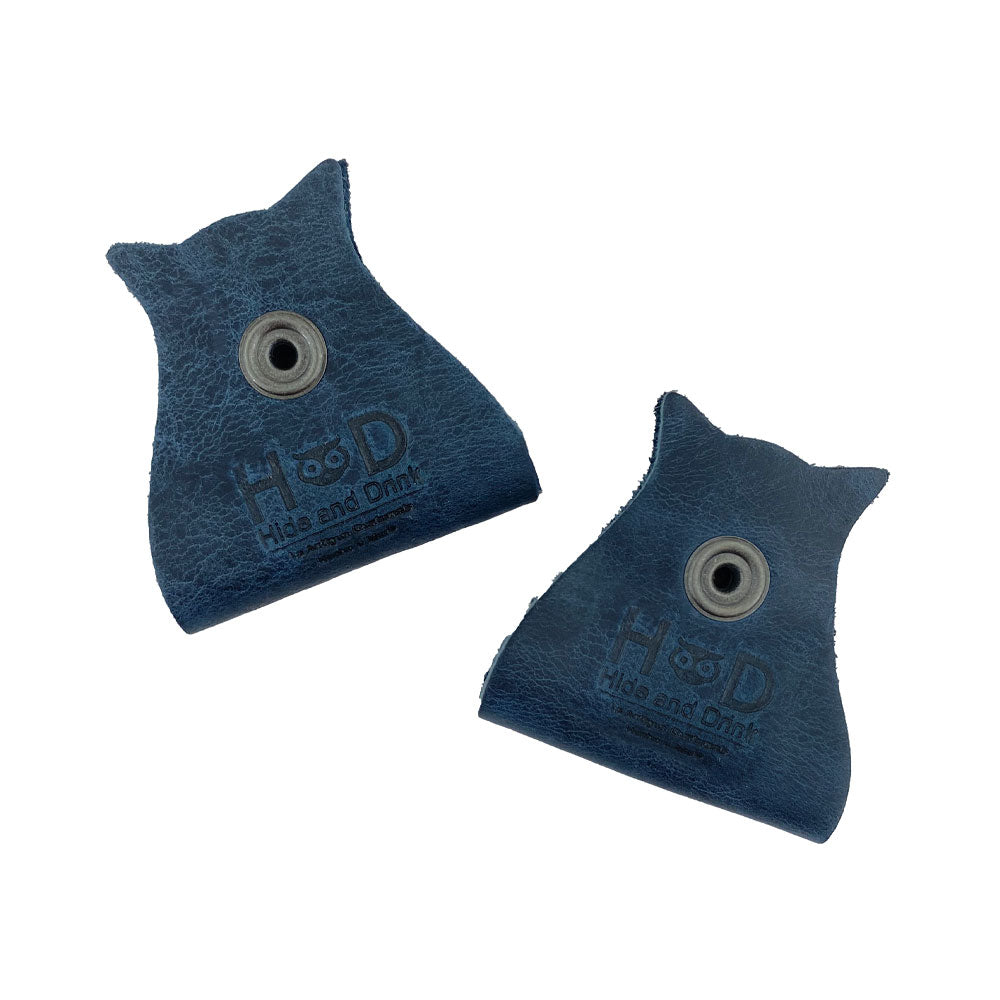 Elegant Owl Shaped Cord Keeper (2-Pack) by Hide & Drink showcasing the brand logo on dark blue leather cord holders that are both functional and stylish. Owl Shaped Cord Keeper (Cord Clam) 2-Pack. Full Grain Leather, StockyardX, Small Batch Production, Hand Cut, Hand Sewn, Fire Branded, Artisan, Handmade in La Antigua Guatemala & Oaxaca Mexico.
